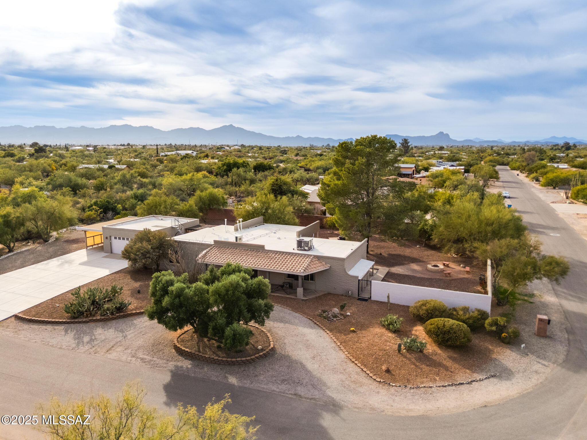 Spectacular 3BD/3BA +Den (2,209 sq ft) home on expansive corner lot boasts NO HOA, Hot Tub, room for a boat, RV, etc. plus front & side Pusch Ridge views along with panoramic upper deck views. Zoned for horses. Roof recently sealed. This formerly expanded home offers slump block & frame stucco construction, 220 amp electric, plus newer HVAC (3 years) & water heater (2 years). Split bedroom plan affords a private, spacious Owner's suite with outdoor access, bench seat entry and walk-in closet, plus sleek updated bath with heated floors, dual vanities, walk-in shower and adjoining laundry room with sink & tall storage cabinets. Two additional bedrooms (one with ensuite bath) plus full hall bath. Front Living room flows to Den with built-in Murphy bed & desk (perfect for additional guests). Beyond lies a Great room with sleek, modern kitchen hosting island with breakfast bar, updated countertops, SS appliances plus ample cabinetry including pantry with pull-out shelves. Informal living and dining area offers dual patio access. Retreat to an incredible pool sized yard offering a covered patio with 2 rolling sunshades, outer BBQ island, Hot Tub and woodburning Fire Pit patio, inset patio off garage with citrus bush and winding staircase to upper deck, plus front & rear desert plantings, drip irrigation and mature shade trees. Circular drive-up entrance plus main driveway off the extended/expanded 2-car garage with workbench and storage cabinets, additional carport and plenty of room at side with 50 amp service for RV. Enjoy serene views from the extended, covered front porch. A true desert retreat in a lovely neighborhood close to schools, shopping, dining and more!
