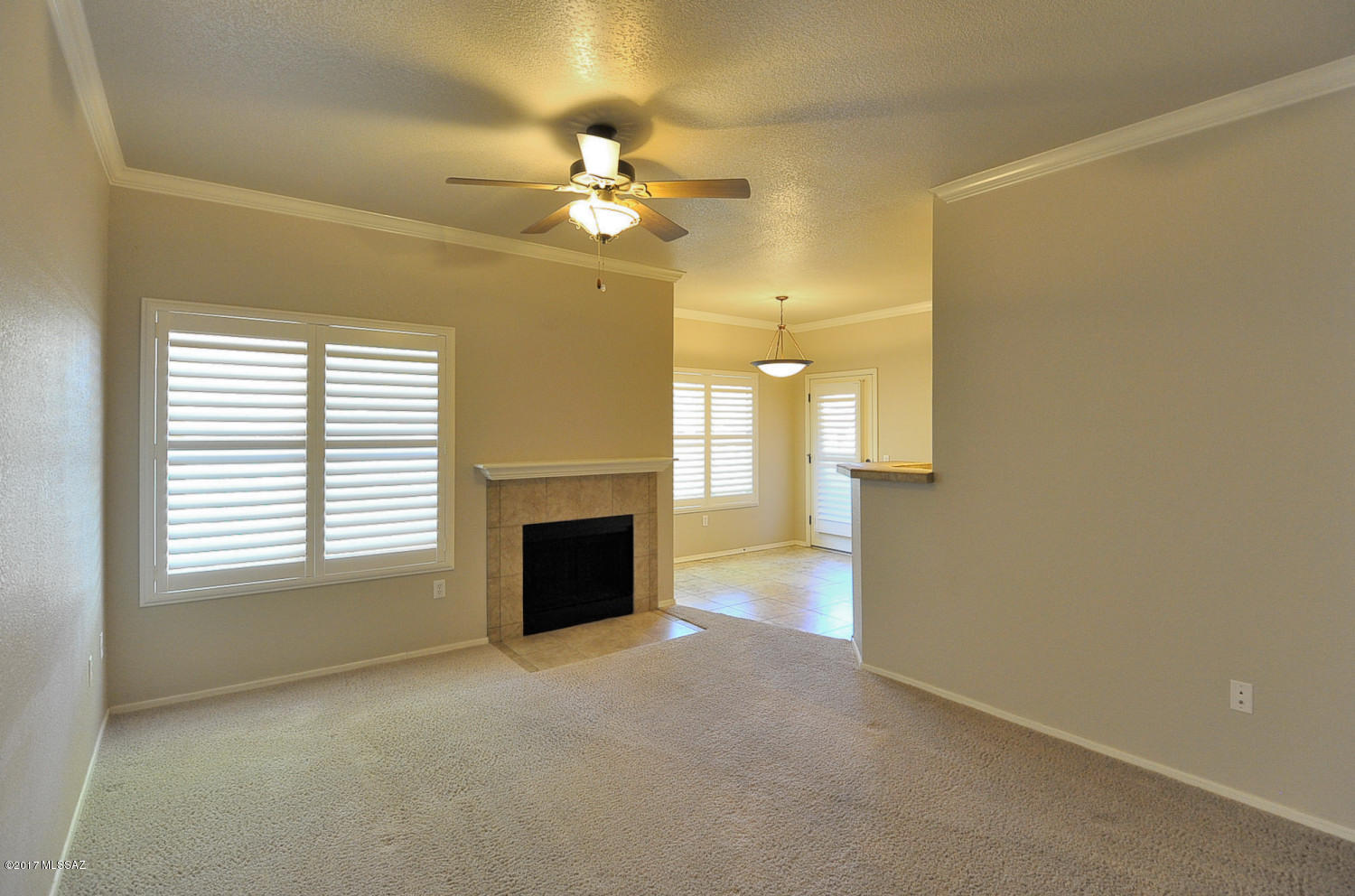 Luxury 3 bedroom 2 bath ground floor condo in gated Pinnacle Canyon. Designer paint throughout, ceiling fans in living room and all bedrooms. Beautiful plantation shutters throughout & crown molding in the living areas. Kitchen opens up into the dining area and living room with a wood burning fireplace. Kitchen has a smooth top electric stove, built in microwave, dishwasher & a large pantry closet. Nice covered patio that is tiled with storage. Resort style amenities include a beautiful pool & spa, large clubhouse, BBQ areas & exercise facility. Lush green grounds! Sabino Canyon Recreation area is just down the street. Close to restaurants, grocery store, golfing and much more. *THIS CONDO COMES WITH A ONE CAR GARAGE IN ADDITION TO A COVERED CARPORT* There is a $959.79 working capital fee.