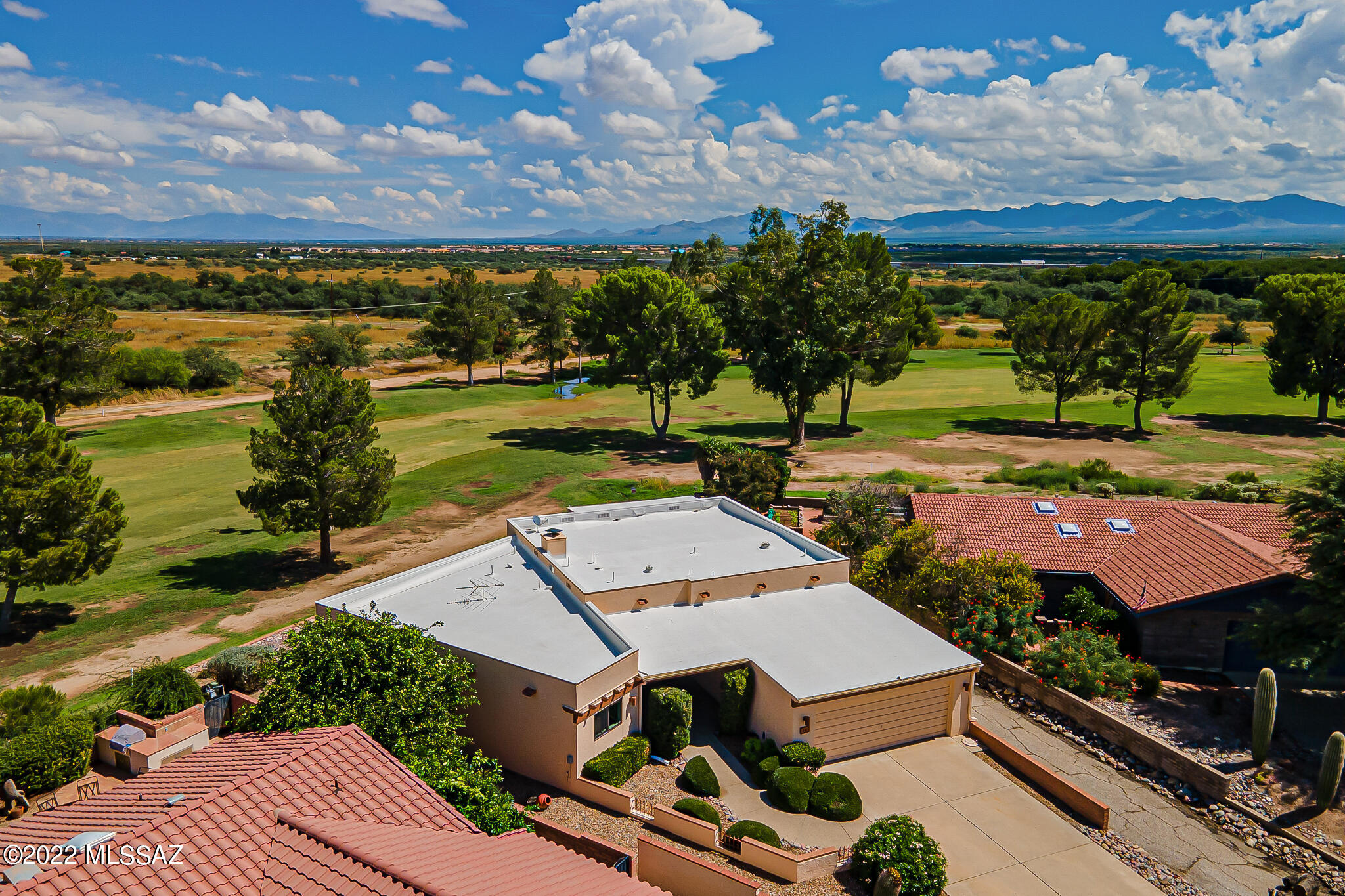 This spectacular home has panoramic views of mountains, golf course green grass, & desert beyond. No homes whatsoever!  Home offers newer windows, flooring, & HVAC system w/variable speeds.  Recently installed a new water re-circulation pump, garbage disposal, and shower valve.  Very large primary bedroom features a large view window, walk in closet and separate media area, which could be changed into another closet. Laundry room w/storage is very handy as its right there! Pour yourself a drink from the built-in bar in living room and sit by the fireplace on those chilly days looking out the large wall of windows to this spectacular view.  Kitchen is spacious with lots of storage, 2 countertop ''garages'', pull out shelving, 2 walk in pantries, interior sunshade on window, 2 lazy susan's. Large garage with a separate storage area. Back patio is both covered & extended with pavers & decorative concrete. Short quiet street.  You'll love the location, view and this spectacular home which has been maintained very nicely.