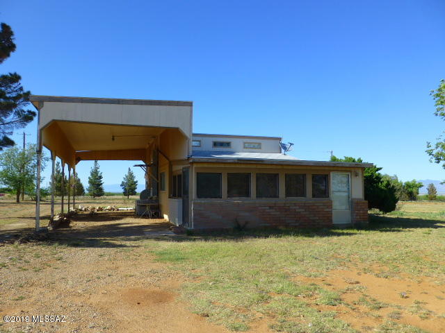 Great location, wonderful views of the Dragoons and the Stronghold, on a paved road.   Nice fix up, lots of potential.   Sunny Arizona room, large storage room with shelves.  RV could be parked under the 2 car carport, what originally built for.   Priced to sale ''as is''.   New roof in 2017 on main house.