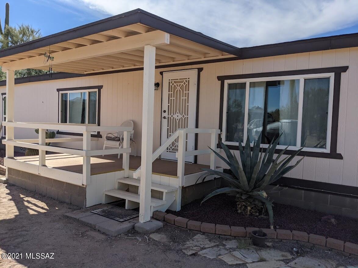 Fabulous home on a Saguaro Studded 2.79 Acre lot.  This 3 Bedroom 2 bath home has built in storage, 2 separate living areas, and a dining area.  Open kitchen has pullouts, and a window over the sink, and a small island.  Large laundry/excess storage area.  Master bedroom is large with huge master
bath, and new Dream Style shower, with drop-down seat. Outside the home has both a front and rear deck, perfect for enjoying outdoor living.  Not 1, not 2 but 3 outbuildings!  25'x32' shop has AC and is big enough to pull in a car! Two other storage buildings (10'x16' and 10'x20') provide for lots of storage.  There's a fenced pool in the yard, and a fantastic Tortoise enclosure!  Dual pane windows, all appliances you see are included, and tucked away off paved Sandario Rd!  What more do you need