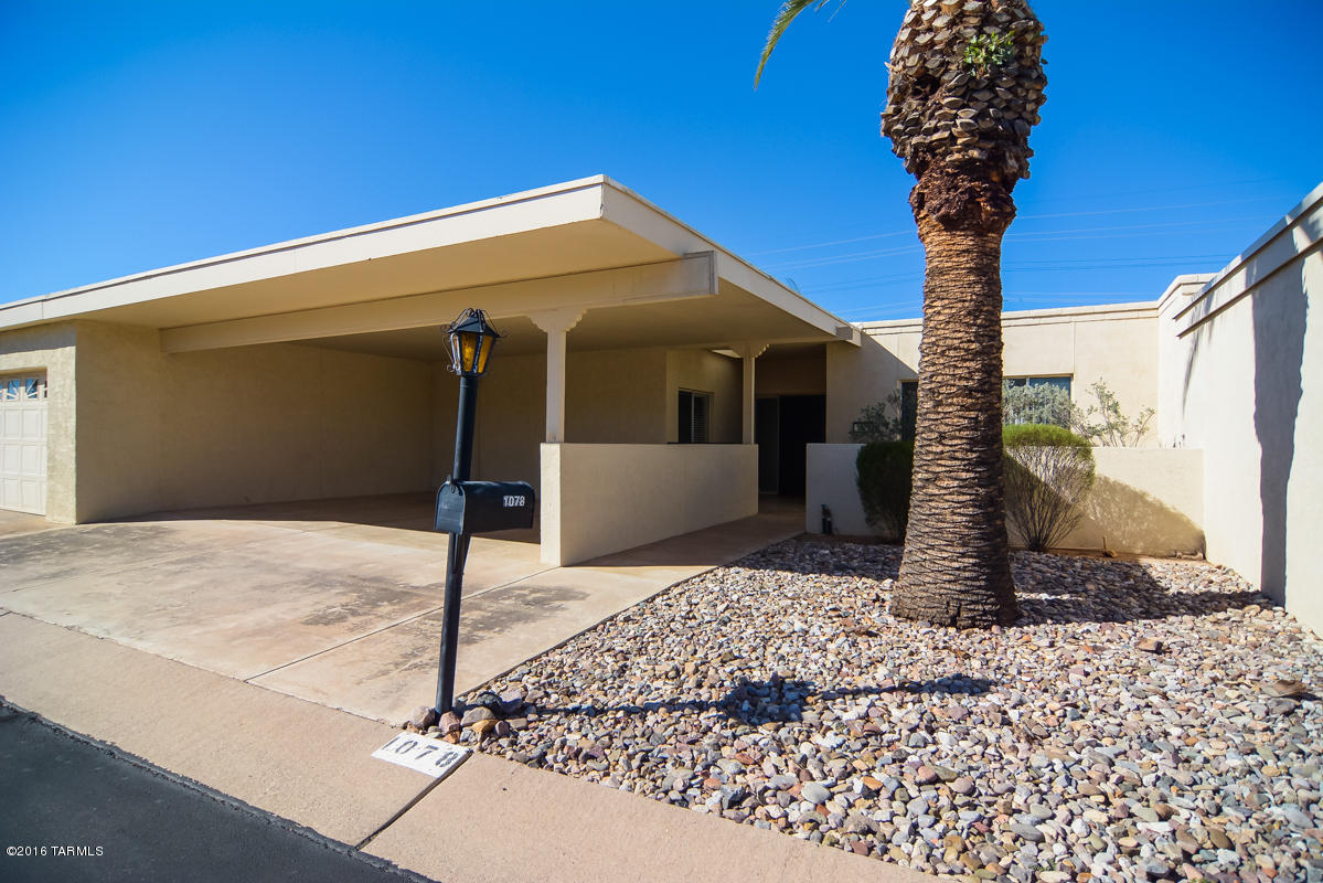 Beautifully remodeled town home. Located in a convenient East Tucson location. Earth toned ceramic tile. Wood floors. Charming light filled kitchen. Modern cabinets and granite counter tops.  Rear porch with a nice walled yard. Fantastic community with many amenities. Two car carport. Upgraded door hardware and light fixtures. This home has many upgrades throughout. Close to shopping and entertainment. Move in ready!