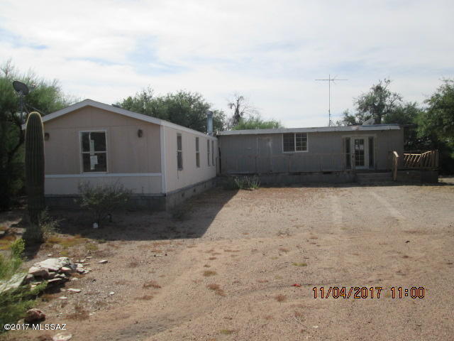 Opportunity to own horse property out in the desert! 2 manufactured homes joined together in an ''L'' shape. A great deal of work would be needed to make them livable. More likely a haul off and bring in a newer unit.