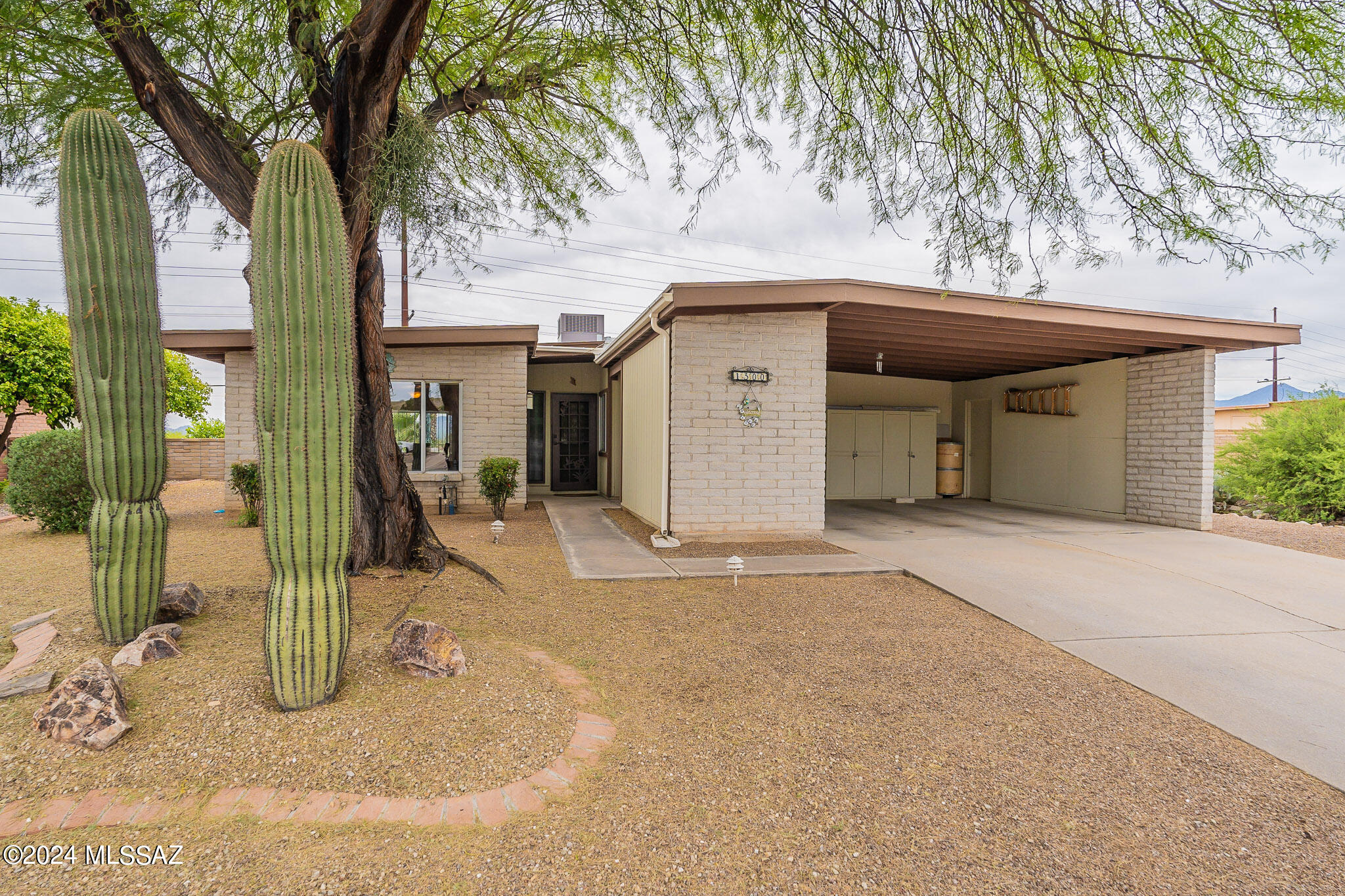 Is a mountain view on your wish list? If so, please check this home out, as it has 180 degree mountain views!  It's a home with 3 BR, 2 BA, on a large lot with great curb appeal.  The back yard is oversized, with palm trees a wonderful water feature, and the Santa Rita mountains serving as a terrific backdrop.  What a great place for entertaining or just kick back and relax.  You'll love the extended living area with a breezeway enclosure, where you can enjoy the breezes all year round, gazing on these beautiful mountains!  Baths have been updated; primary has a jetted tub with shower.  Kitchen is very light and bright with plenty of work space.  Separate storage room off carport.  There's a Kinetico whole house filtration system, too. Don't miss this hidden gem; it's the real deal!