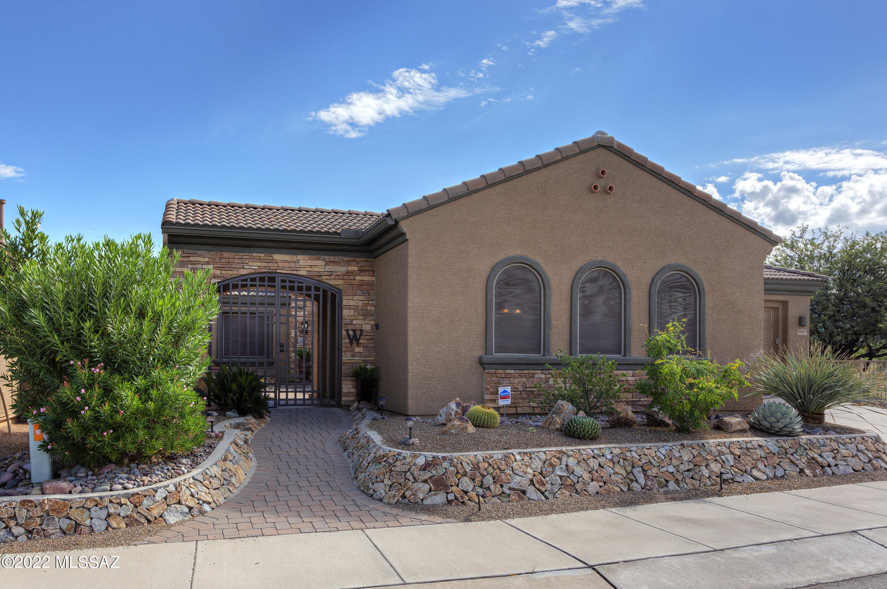 View, privacy, luxury - all wrapped up in a gorgeous home and panoramic views! Enter the front locked gate to find a beautiful paver courtyard with fountain and sitting area with fireplace. To the right is the fully furnished casita. With 2 bedrooms and an office with built-ins in the main house, this former model home is absolutely exquisite. Appointed throughout with cherry cabinets topped with crown molding, granite countertops, beautiful travertine and hardwood floors, custom window treatments, recessed lighting, decorator ceiling fans and light fixtures, and surround sound. Outside, you'll enjoy the covered patio with remote controlled sun screens, the water feature and desert landscaping in the backyard. Recent improvements. New HVACs 11/21; exterior paint 6/20; water heater 11/20.