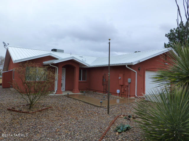 3 bedroom 2 bath home on a corner lot where 3 sides are golf course and no other homes will be built. Nice patio on golf course with large fountain. Metal roof and stucco exterior. Lighted flag pole, irrigation system, alarm system, gutters and downspouts, low care gravel yard front and rear, large 3 car garage with floor to ceiling cabinets, newer gas pac heating and cooling system. Inside laminated wood floors and granite counter tops. This is truly a nice home, a must see to appreciate.