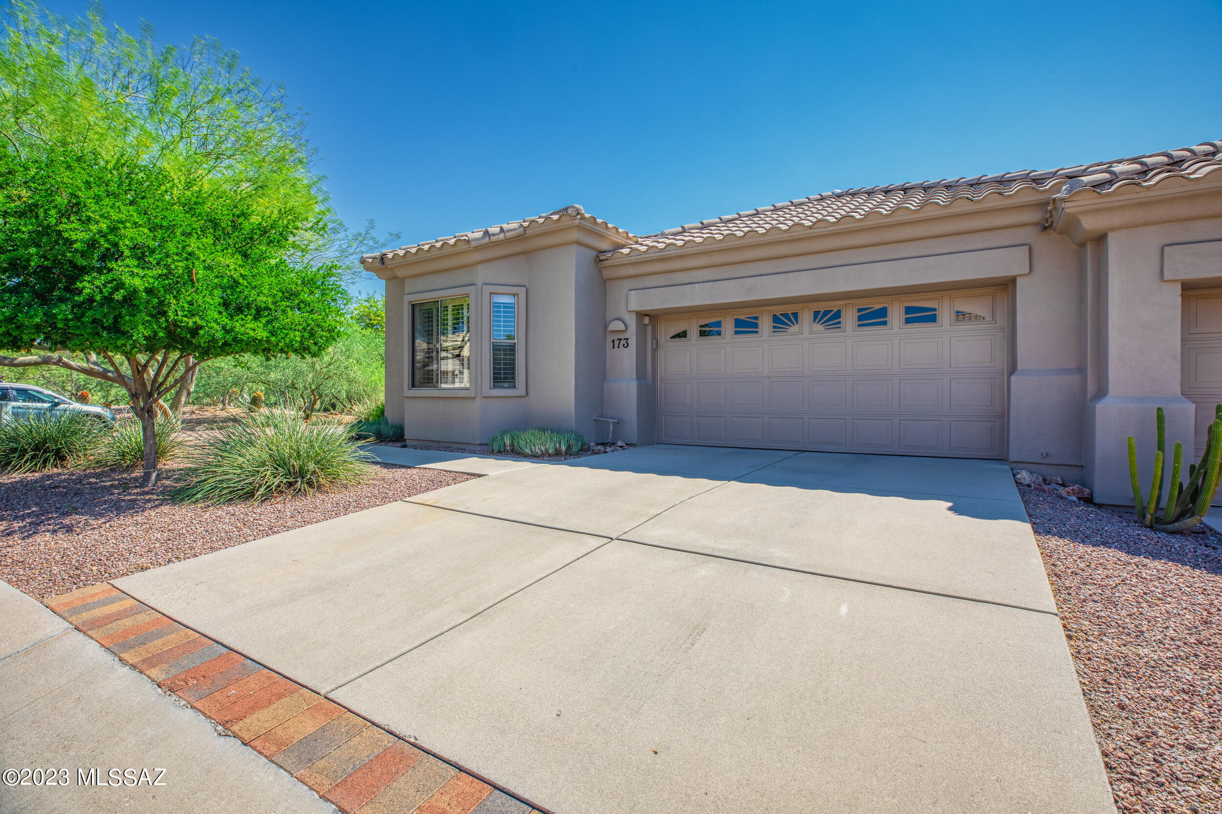 Located in the gated community of Vistoso Village in the heart of Oro Valley. This wonderful, active adult community offers abundant amenities. This immaculate home is extremely private surrounded by trees & vegetation. Peek of the mountains too. It boasts 2 spacious bedrooms plus a den and 2 renovated bathrooms. Den is versatile making a perfect TV room, hobby room, library (whatever suits your needs). Plantation shutters in each room. The home is flooded with natural light & the neutral colors create a calming place to call home. Enjoy the Tucson weather from your private back patio with remote control screens. See attached for full list of improvements, offered amenities and what the HOA covers (roof, exterior paint, water, internet, cable, structure insurance, trash, pest, yard)