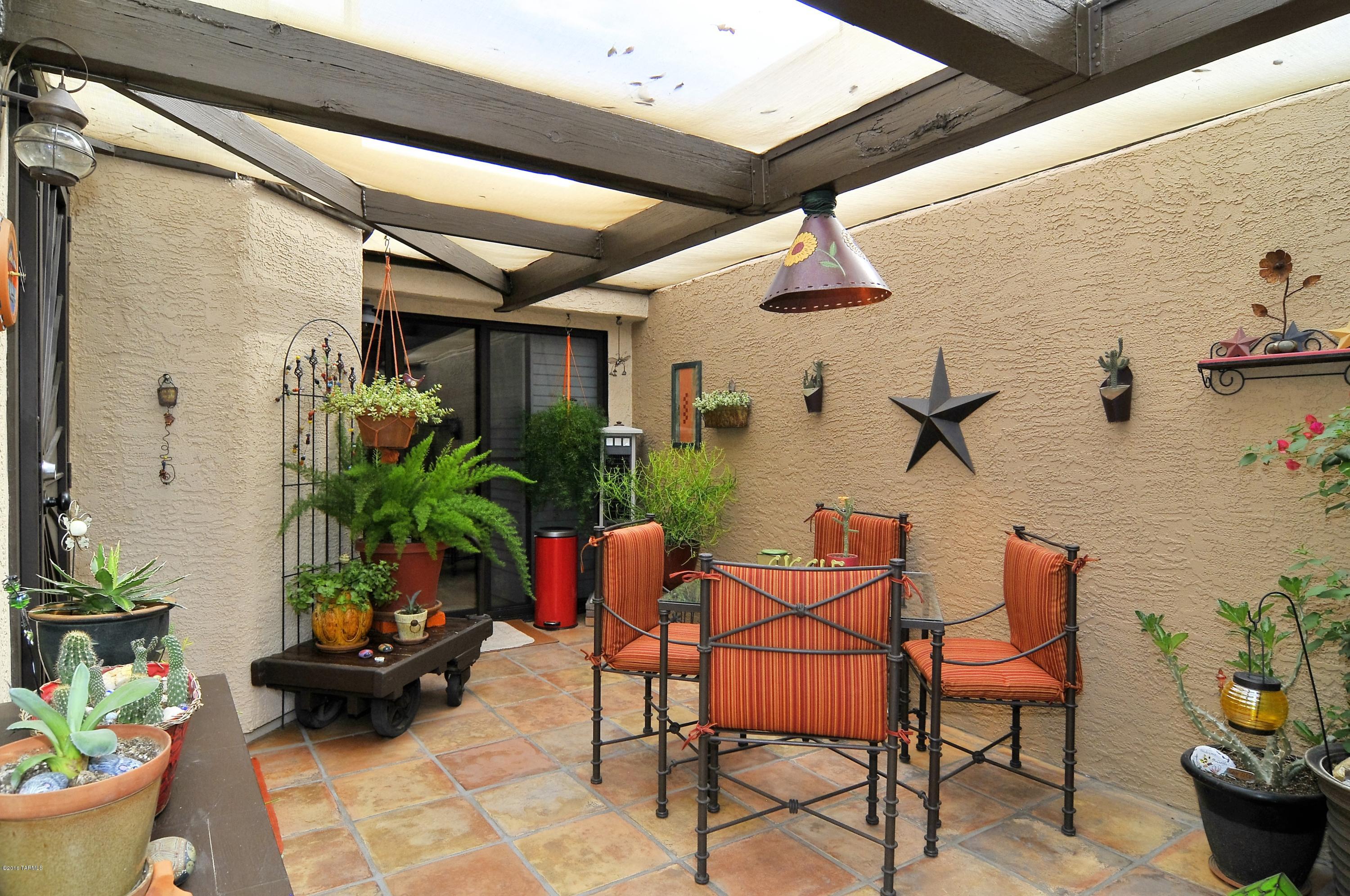 Model Perfect Condo Full of Charm! Private courtyard with Saltillo tiled floor, shade & lots of room for lounging! You area greeted with soaring ceilings in the open living, dining rm & kitchen area. Tons of upgrades! Stunning wood staircase, built-in nooks, wood-like flooring, professional 2-tone painted interior plus decorative ceiling fans & light fixtures throughout. Cabinetry has been professionally refinished & looks amazing! Kitchen offers a built-in microwave, storage & bar seating opening to the gathering area. Downstairs 2nd bedroom is currently being used as a Den, it offers high ceilings, nooks & private access to the courtyard! Beautiful Plantation window shutters, bathrooms feature custom tiled backsplash, decorative mirrors & medicine cabinets. Gorgeous Community Pool & spa!