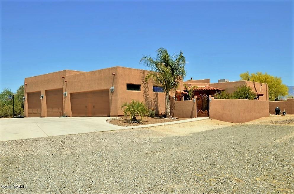 Gracious and comfortable custom split bedroom home on 2.36 AC with 3 bedrooms, family/game room, plus den/media room, pool, corral and arena and easy access to horse trails. It's all here! Beautiful beam ceilings, saltillo floors throughout, huge bedrooms with large closets, huge laundry room, more than abundant storage! Knotty oak cabinets in kitchen with gas range, additional oven, microwave/convection oven and great mountain views. Backyard is a family haven with Kiva, separate ramada, fabulous solar heated Pebble sheen Patio Pool - 18.5'x 32.5' with diving board, hot tub, and firepit. 1680 sf-4 car garage -(900 sf with RV height-heated/cooled workshop). Vigas, high ceilings, skylights, ceiling fans, double pane windows, zoned heating/cooling, lots more!