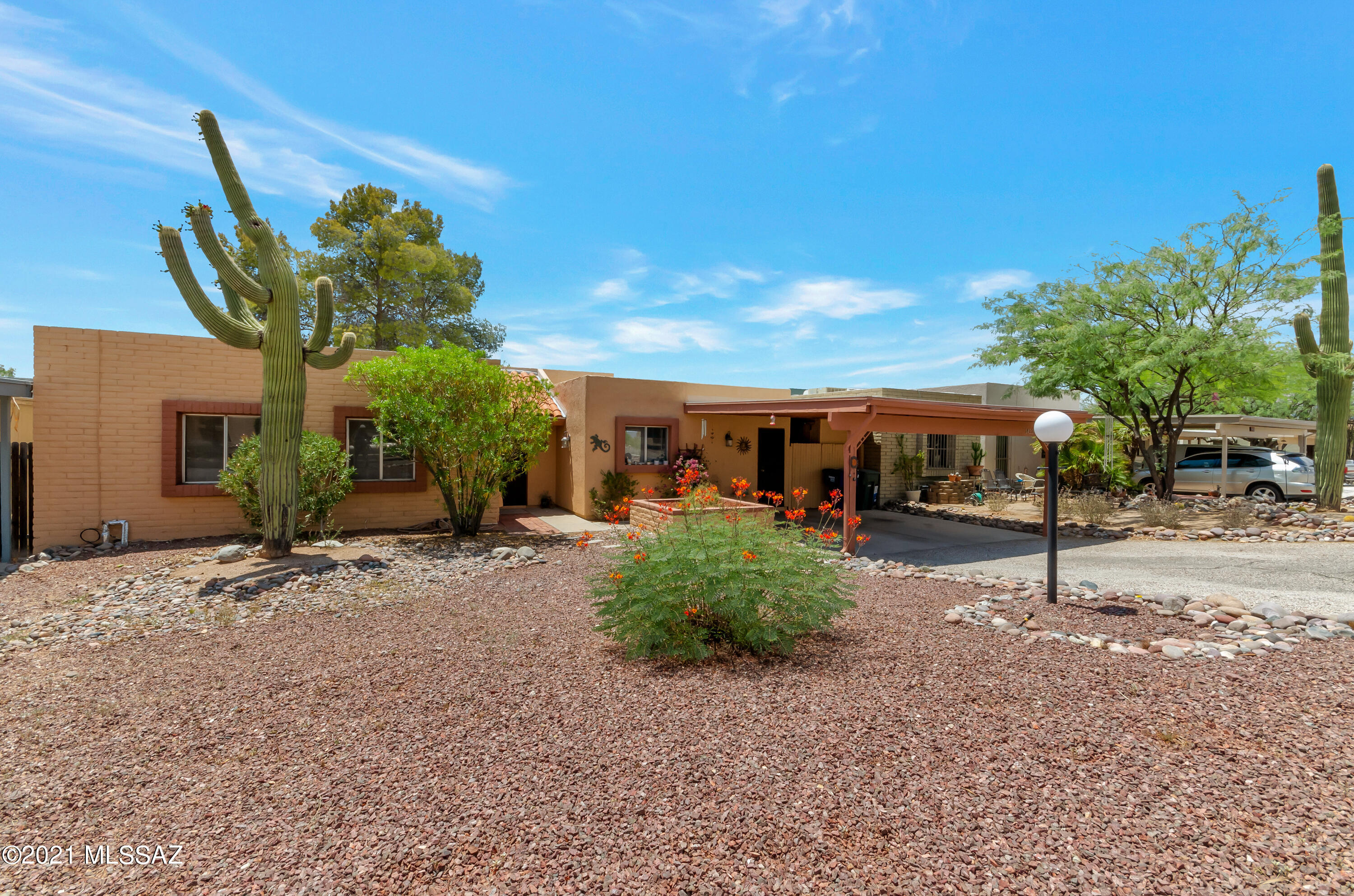 Nestled in one of the most scenic parts of town with the Rincon Mountains to the east and the Catalina Mountains to the North, this townhouse in the peaceful Village Greens is far enough away from the hustle and bustle of the city yet close enough to all the amenities you need. New dishwasher and stove, roof was just worked on and comes with a 2 year warranty, AC recently serviced, BRAND NEW water heater, new ceiling fans, and a  beautiful and relaxing covered patio in the back looking on to a large backyard with only desert behind you are among some of the great features this place has.