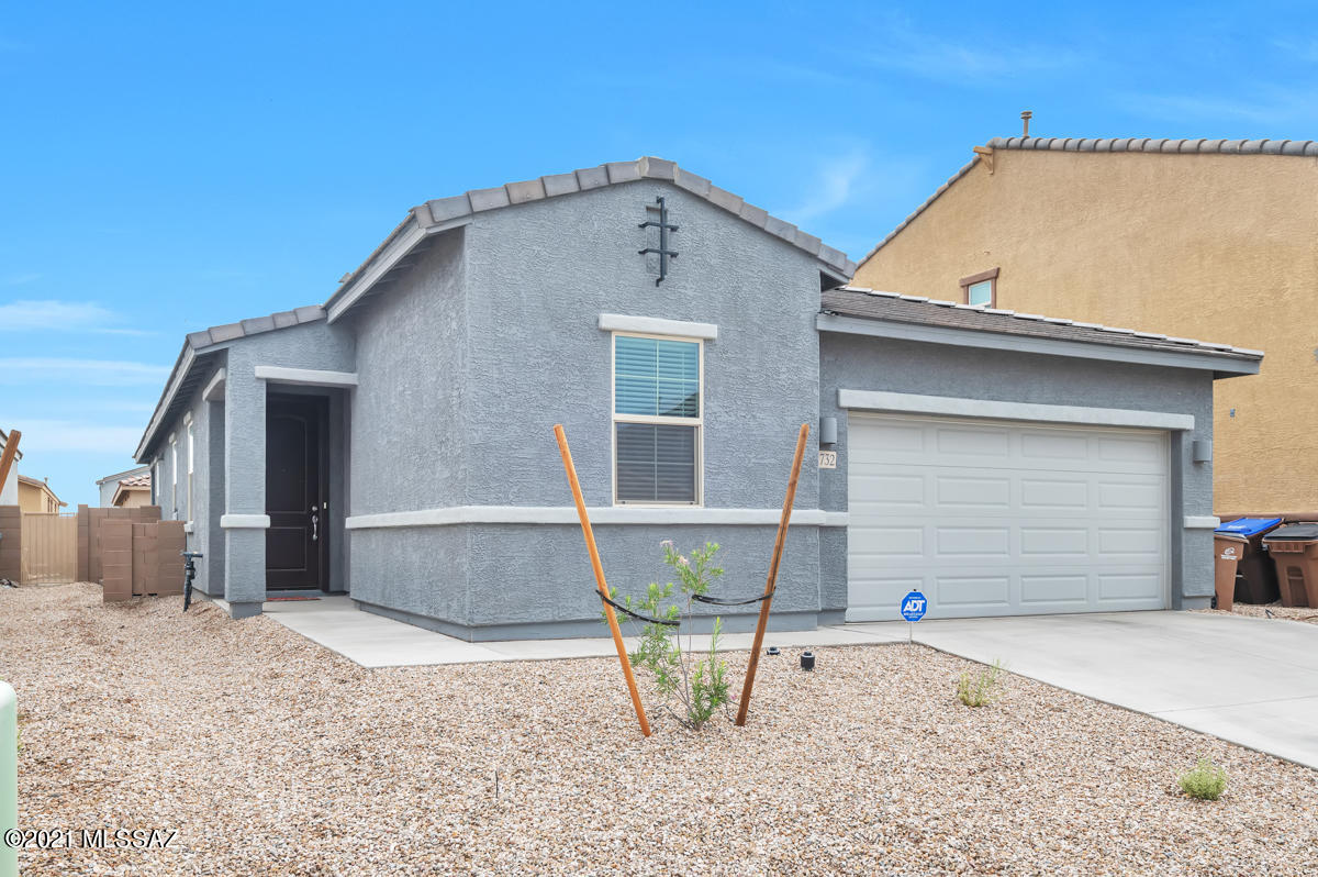 Just like NEW! Don't miss this energy-efficient 1912 sq ft, single story home in Marana's beautiful Gladden Farms community.  This lovely home offers 4 bedrooms and 2 full baths with room for your whole family.  The kitchen offers a kitchen island, Granite countertops, stainless steel appliances and an eat -in kitchen. This lovely home has 12''X12'' tile in Matte Taupe, neutral carpet, and neutral paint throughout.  Enjoy lovely Arizona Evenings on your back patio or playing in your fully landscaped backyard with low maintenance artificial turf.  Water softener, security system and washer/dryer are included for your convenience.   You will also enjoy access to recreation areas with a splash pad, sports courts, fields, walking paths and parks.  See this home today!