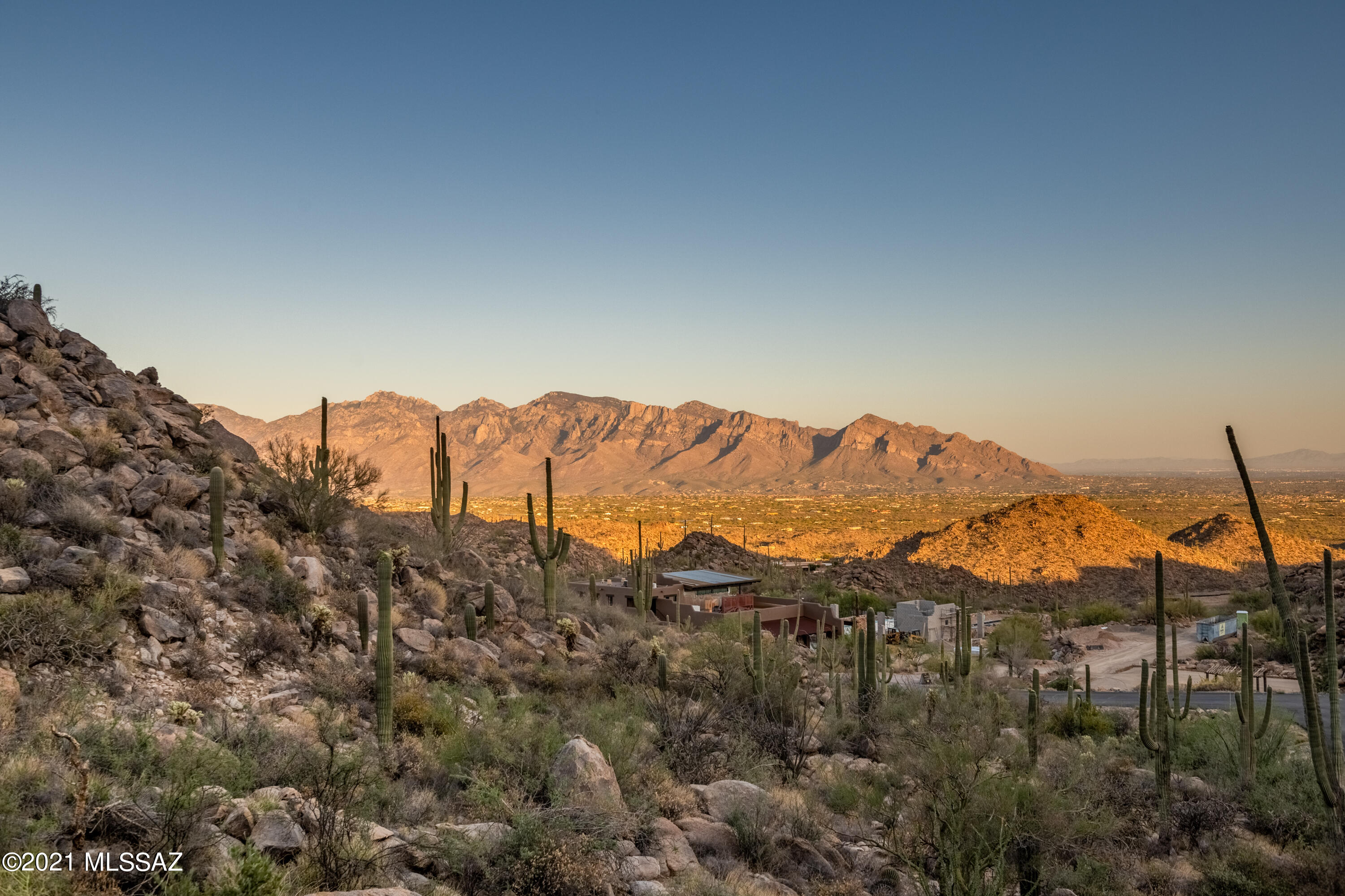 King of the Mountain - Hilltop Acreage in Saguaro Ranch. Arrive thru the coveted tunnel entrance in style.  Boulder Outcroppings and Saguaro Cactus consume this lot in a way that makes for a unique and unimaginable setting. Views you could only imagine of the entire city including the Santa Catalina Mountain Range and off into the distant view you will see mountain ranges for days.   Clubhouse is currently under construction soon to be complete with fitness center, gathering spaces, pool and spa with endless views.   Membership is optional.