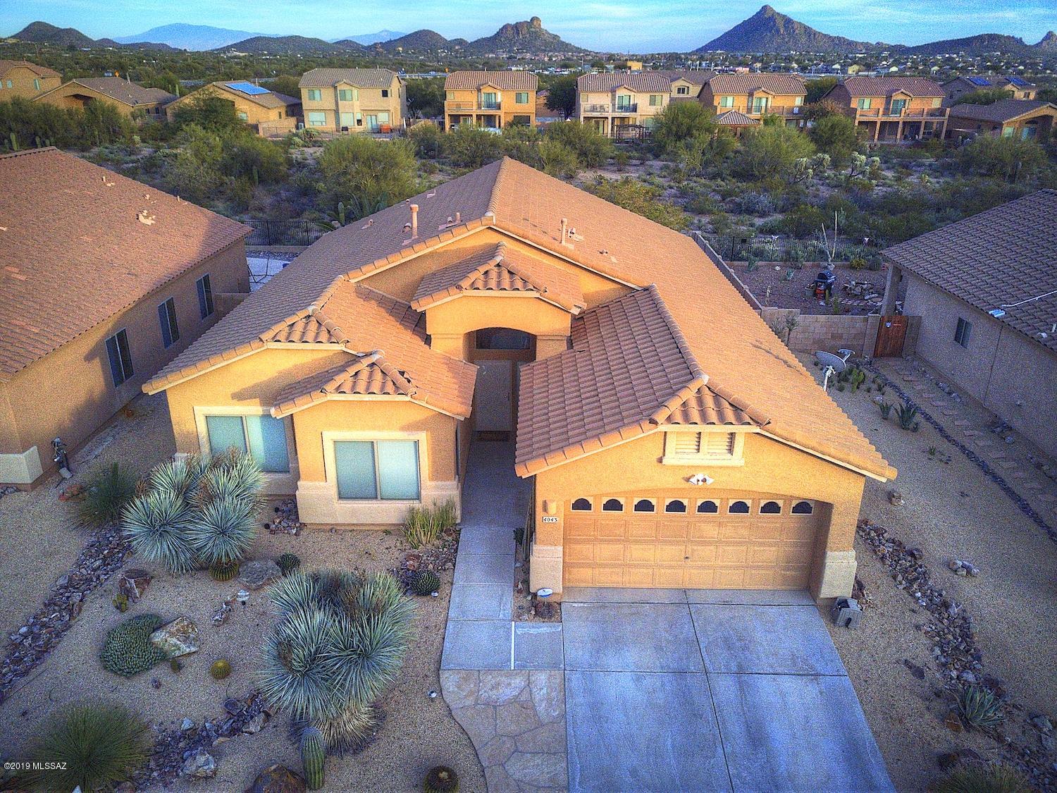 Located in the beautiful Shadow Mountain Ranch community, This gorgeous 4 bdrm/2bath home is in model home condition. Vaulted ceilings, open floorplan 
 and a cozy fireplace. Kitchen boasts granite counter tops, tons of storage, and a large island. Garage is comfort cooled and low maintenance landscaping enhances the beauty surrounding this gem. Gorgeous views of Cat Mountain in the Tucson Mountains (or Tucson mountain range) from the backyard, during the 4th of July, Firework shows can be seen from 'A' mountain and Del Sol Casino! Come see this one today, it will not last.