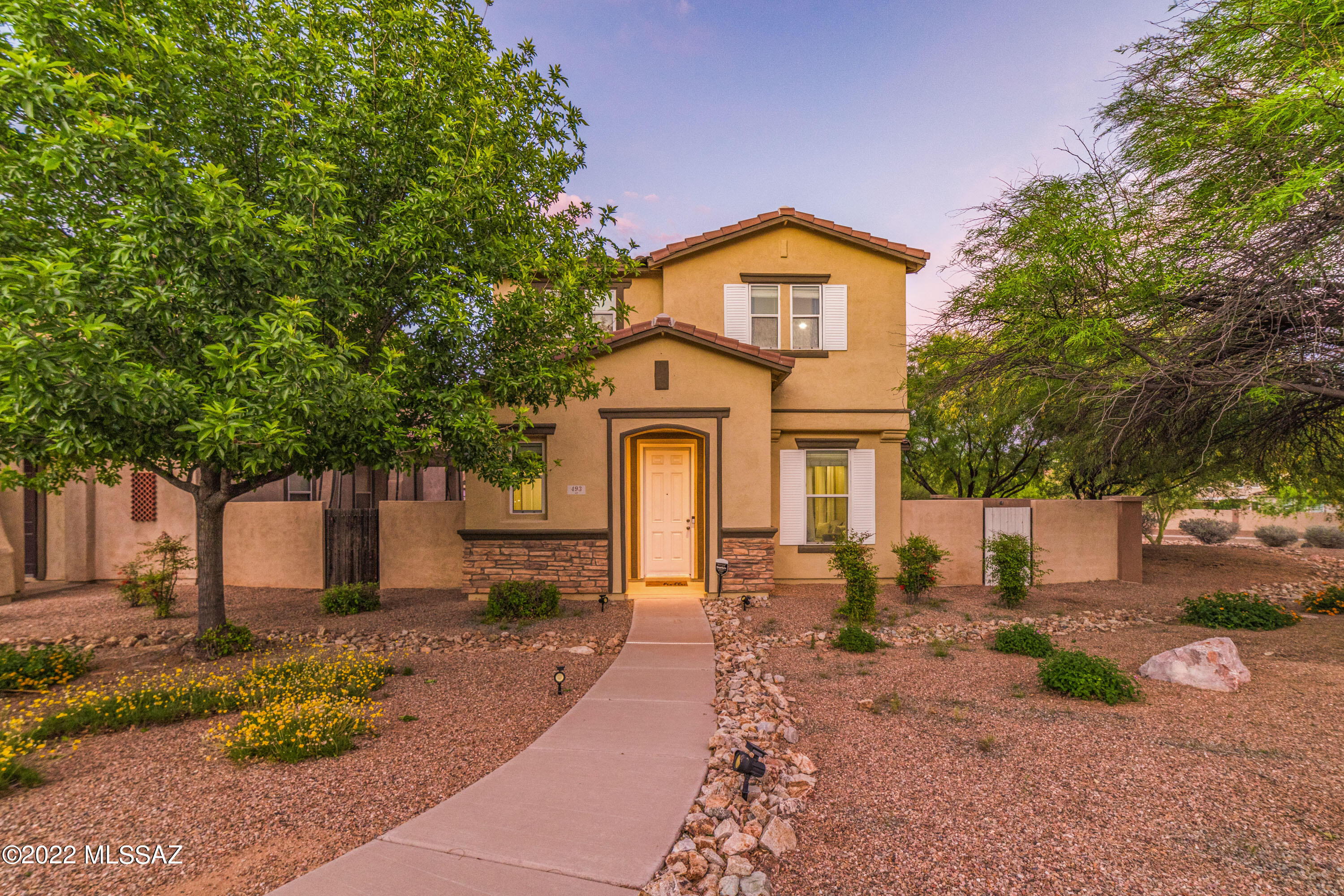 Unmatched Sanctuary in the Prestigious Award-winning neighborhood of Rancho Sahuarita. Exquisite, open-concept design, white kitchen cabinets, white tile backsplash and white quartz counter tops. Kitchen is equipped with black appliances and gas cooktop. This three bedroom two and a half bath home is charming and immaculate. Home improvements include tiled first floor, quartz counter tops, smart garage opener, ring doorbell, designer paint and a landscaped patio with turf and pavers. Enjoy entertaining friends and family in the private and serene patio that borders community common grounds. The massive master bedroom will become your most favorite retreat, boasting tons of natural light and space.
 Come take a look before its gone!

 Refrigerator, washer and dryer convey with sale.