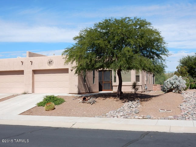 Beautiful  end unit townhome backing to open desert in sought after Active 55+ Las Campanas close to GVR center, shopping, dining and I-19. Great 2005 built two bedroom, two bath with enclosed, covered screened porch.  Great room concept and split bedroom plan. Ceramic tile flooring throughout except bedrooms. All appliances stay including washer and dryer. All window coverings and 3 ceiling fans included.  Roof recoated January 2015. Bills Home Service termite warranty. Immaculate and move-in ready.