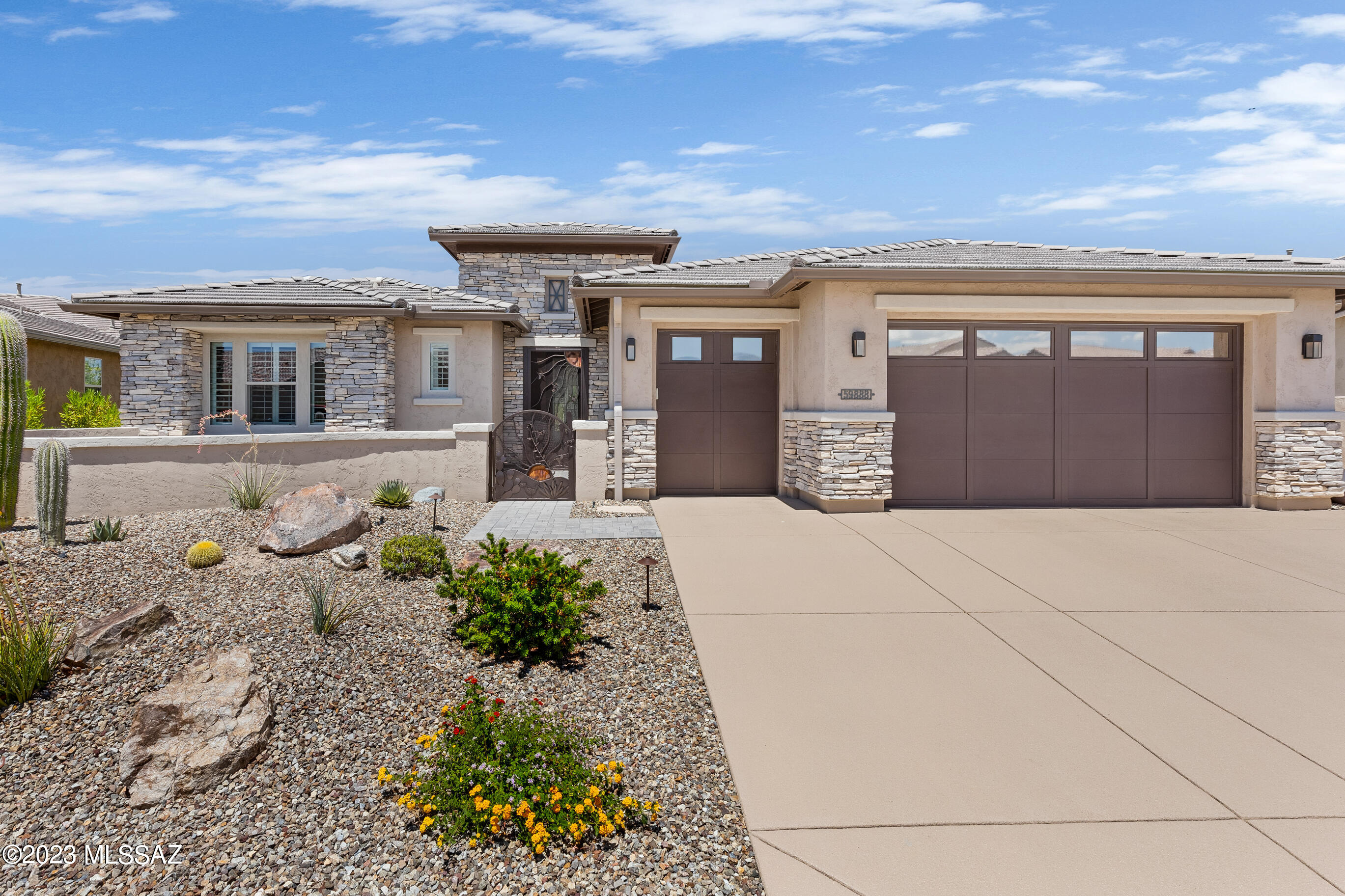 Elegant, like new, upgraded Tesoro is the perfect desert home. Located on a premium lot backing to open space in SaddleBrooke Ranch. A warm contemporary interior features ''wood'' luxury vinyl flooring throughout. The great room has an artistic media wall with fireplace and double glass sliding doors to the patio. Extended covered patio with auto screens & built-in gas barbecue. Resort backyard features salt water heated pool, w/waterfall, extended patio, gas fire pit & water fountain. Chef's Kitchen has sleek quartz counters & tile back splash, gas cooktop, w/ stainless hood vent, convection wall oven & Advantium microwave. Butler's & walk-in pantries. Extensions on Master bedroom & closet, den, covered patio and garage. Epoxy garage floor, 2 utility sinks & water softener. Extensions to base floor plan include:
3 Ft. on Den. Sliding bar door.
2 Ft. on Master Bedroom and 6 Ft. on walk-in closet.
4 Ft. on front of garage.
10 FT. on depth of covered patio and extension behind dining room.
4 automatic remote-controlled patio screens. 
Patio ceiling fans.
Solar powered string "party" lights on covered patio ceiling.
Den with sliding "barn door".