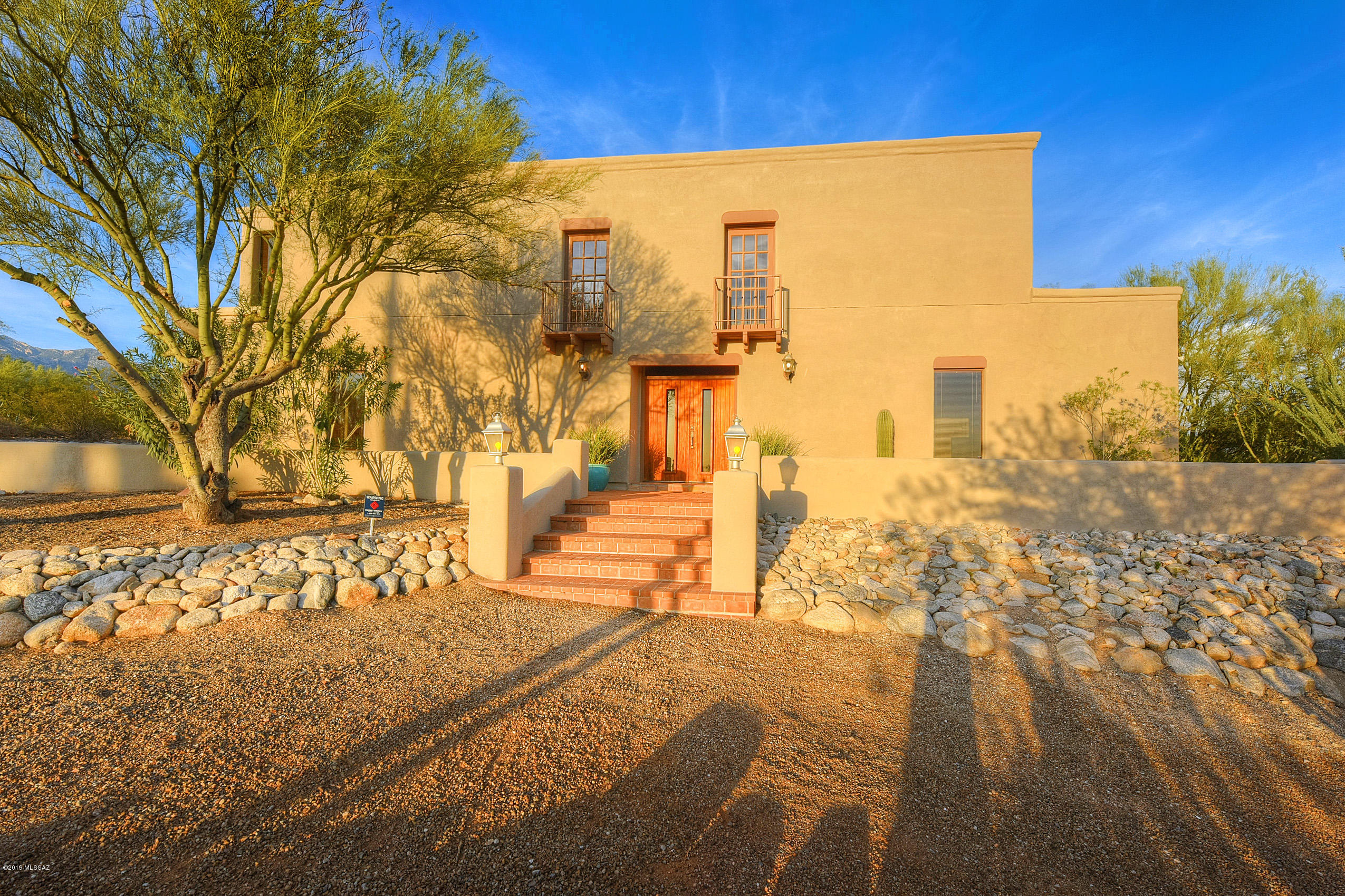 Private Foothills property that sits on more than 3/4 of an acre with 4,049 Sq Ft and 4 bedrooms, 3 bathrooms. Spacious great room with 16' viga beamed ceiling and large viewing 1/4 inch glass windows that stretch floor to ceiling. Handmade Talavera tile in kitchen and bathrooms, large walled in backyard with real grass, lap pool and serene Foothills desert views. Private master suite is only room on the second floor with beehive fireplace, french doors leading to private balcony and incredible views. Master bathroom has Talavera tile, dual vanity, walk-in shower, separate jacuzzi bathtub. Four bedrooms, three bathrooms and entertaining spaces in the awe-inspiring Great Room. Large kitchen with island and large pantry.