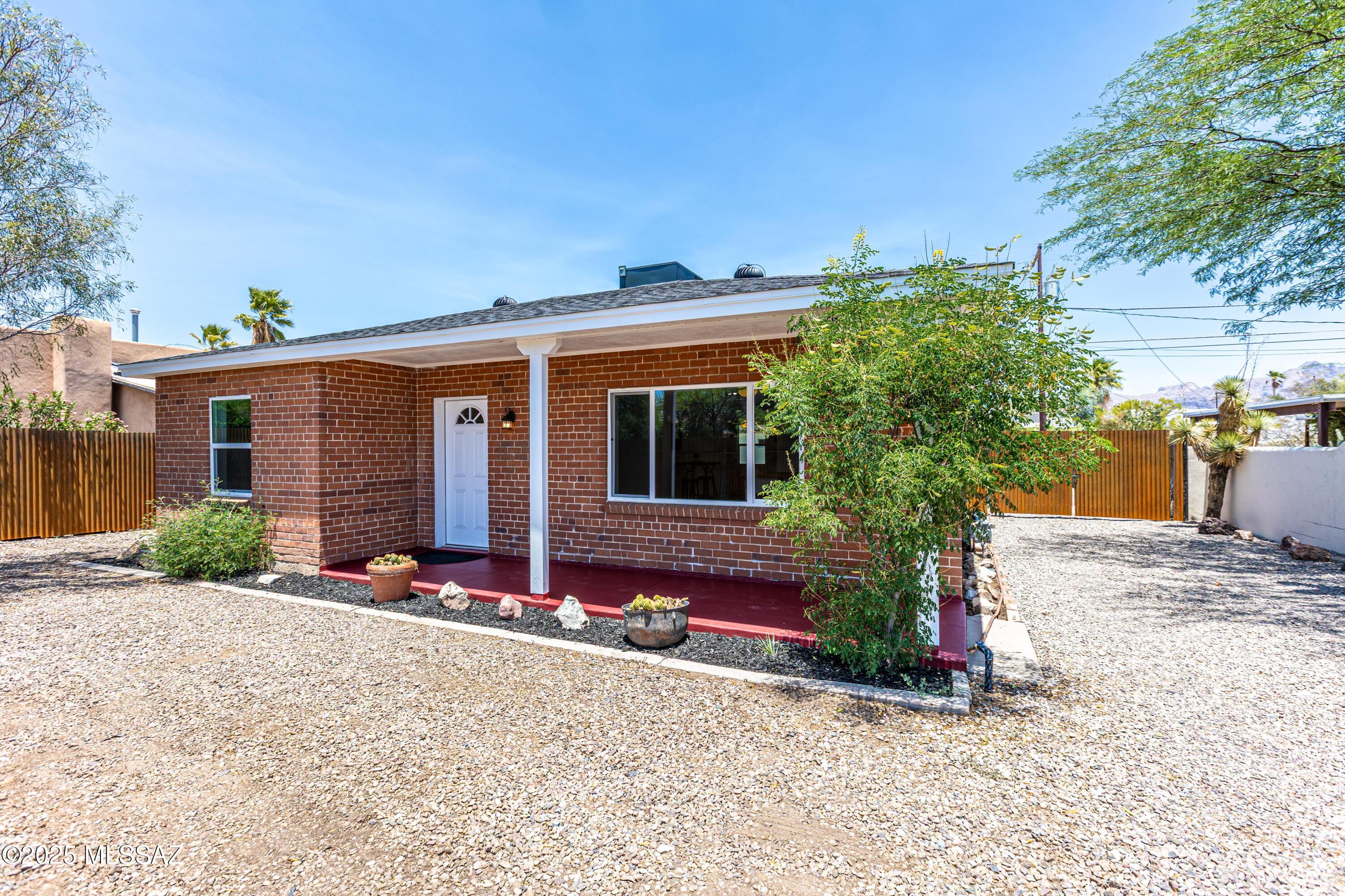 Seller will accept or counter offers in the range $467,700- 483-700.00. House plus Guest House... live in one and rent or Air BnB the other!  Great location, less than 5 minutes to U of A.   Main house is 3/2 with 2 spacious living areas a large breakfast bar nice blend of public to private spaces.  Wonderful full length covered screen porch.  Guest house is 2/1 with Open Kitchen/Living & Dining area.  Each unit has separate laundry with hook ups for full sized laundry.  Tile floors throughout both units , custom tile shower surrounds plus new dual pane windows and doors throughout.  New shingle roofs.  New HVAC.   Electric panel upgraded to 200 amp.   All new sleek modern finishes throughout both units.  Driveway Gated at front and back with alley access.  Large Yard.  Unique set up that so much flexibility.  Just minutes to I-10 access.  No HOA.