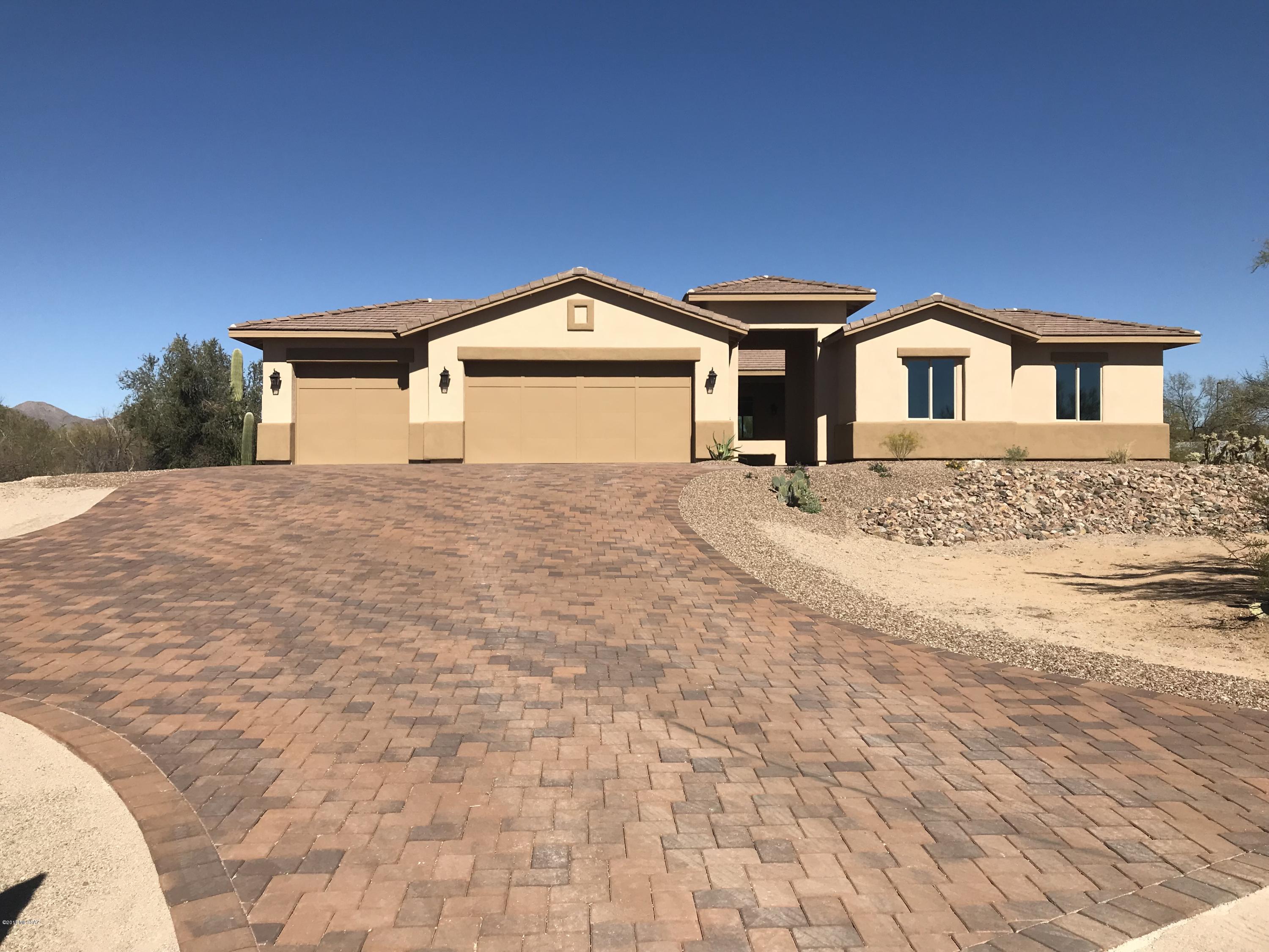 New construction built on 1 acre in Northwest Tucson. Lovely paver driveway & welcoming courtyard usher you into attractive & functional floor plan featuring foyer, formal dining room, office & great room with 12' center sliding door. Gourmet kitchen boasts quartz counters, Kitchen Aid appliances, double ovens, composite sink & expansive island. Split bedrooms with ''teen room'', 2 bedrooms & full bath on one side of home, 2nd master en-suite with roll-in shower & walk-in closet on another part of home-perfect guest quarters. Spacious master suite features split vanities, garden tub, beautiful shower & over-sized walk-in closet.Large laundry room with cabinets, quartz counters & sink. Extended 3 car garage with additional workshop space. No HOA,connected to city sewer & water. Horse property-room for all your toys with no HOA restrictions.Energy efficient home-upgraded HVAC Heat Pumps 16 SEER variable speed, state of art heat pump water heater, soft water loop and RO plumbed in sink. 400 amp electrical panel.Check out staged model for sale next door - MLS #21801833

Photos reflect model home for sale next door- MLS#21801833