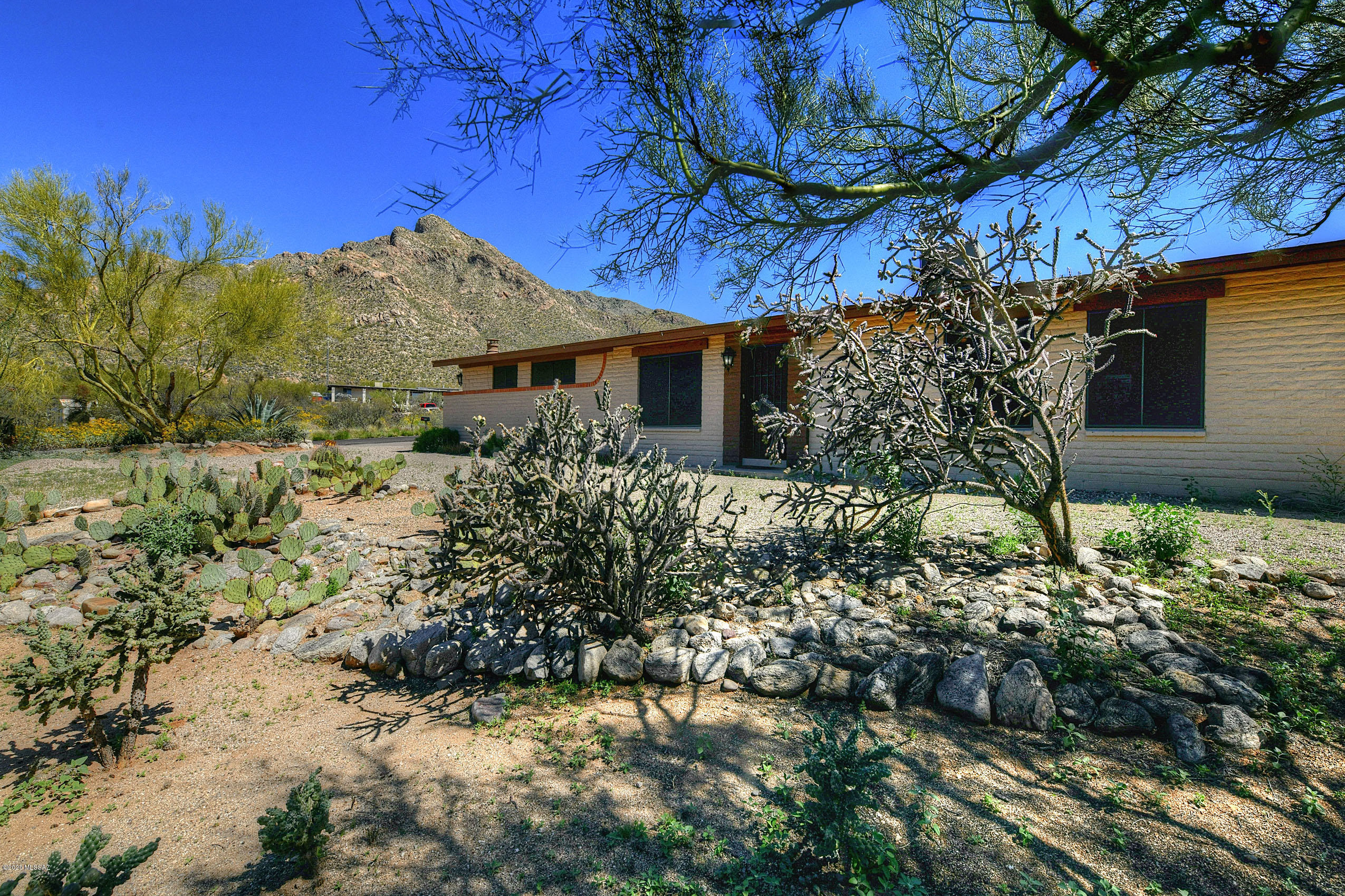 Fully remodeled home set on picturesque lot! Gorgeous panoramic, sunset, and Catalina Mountain views! Nestled in the foothills of Oro Valley close to shopping, entertainment, and activities. Open great room floorplan with ceramic tile flooring throughout. Newer HVAC, water heater, and roof. Kitchen built for entertaining with breakfast bar, massive island, granite counters, and updated appliances. Great room complete with picture window view of the Catalinas and gas burning fireplace. Backyard has covered patio, high quality turf area, firepit, and horshoe pit. Currently the garage is soley functioning as a storage or workshop area. Check this one out!