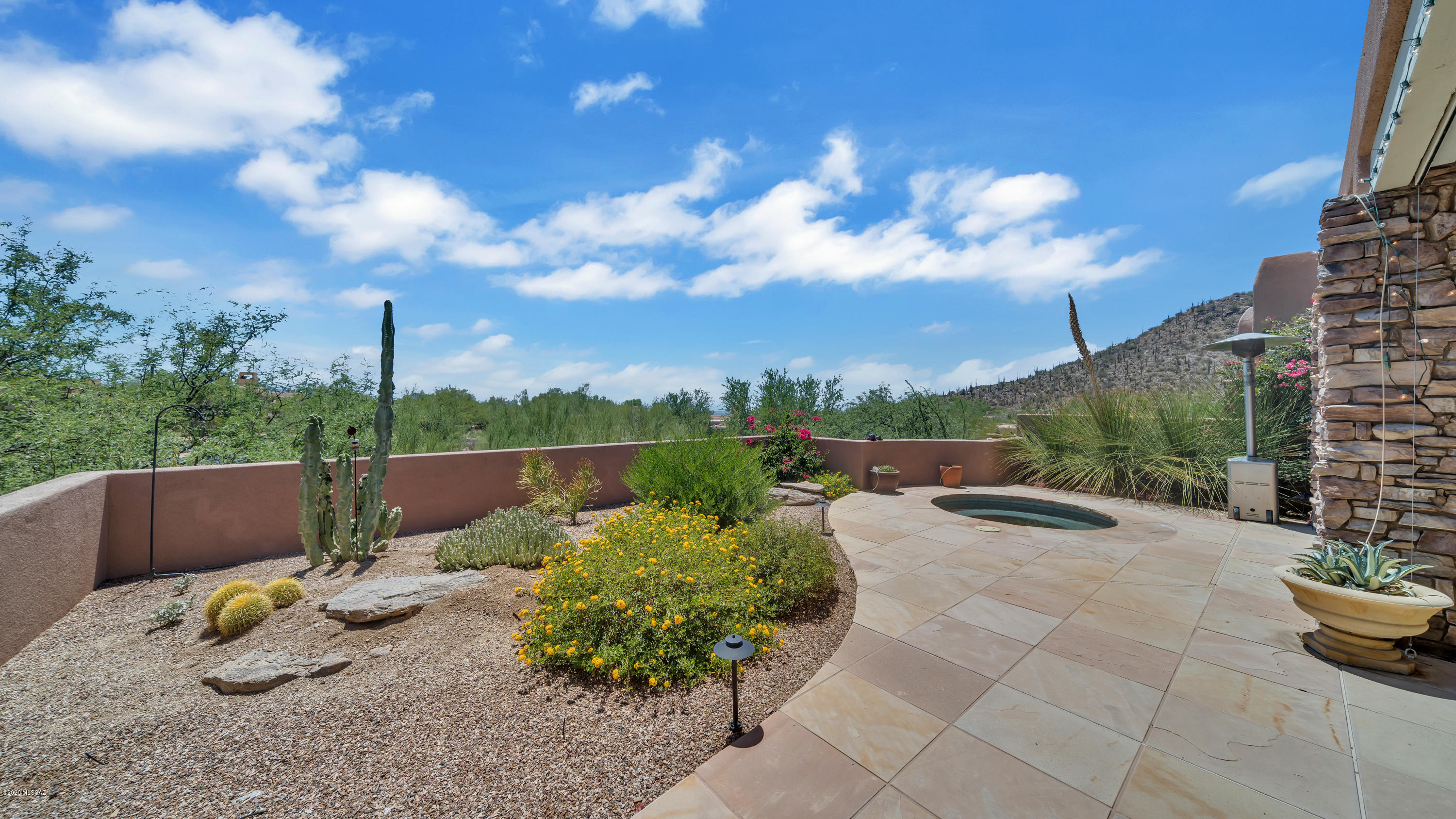 Popular lock & leave Gallery Cottage nestled in the Tortolita Mountains! Foyer opens to expanded great room, dining area & wine bar. Spacious kitchen w/island, breakfast bar, gas cooktop, built in fridge. double wall ovens, micro-GE Profile appliances,  desk, dining nook.. Nearby, laundry w/ sink, counters, cabs. Garage has storage cabinets. Sweeping master BR, w/ wall of windows/sliding doors w access to patio. Dual closets, soaking tub, shower w/bench complete your sanctuary! BDRM 2 has ensuite BA &, CTYD access, BDRM 3 utilizes hall BA & also has CTYD access. Huge slate patio w/ built in spa, BBQ, gas FP, remote shade, all w/stunning mountain views! Slate & travertine floors thru-out, roof resealed 5/20, Ext paint & water heater 2018. Furnishings available on separate bill of sale.