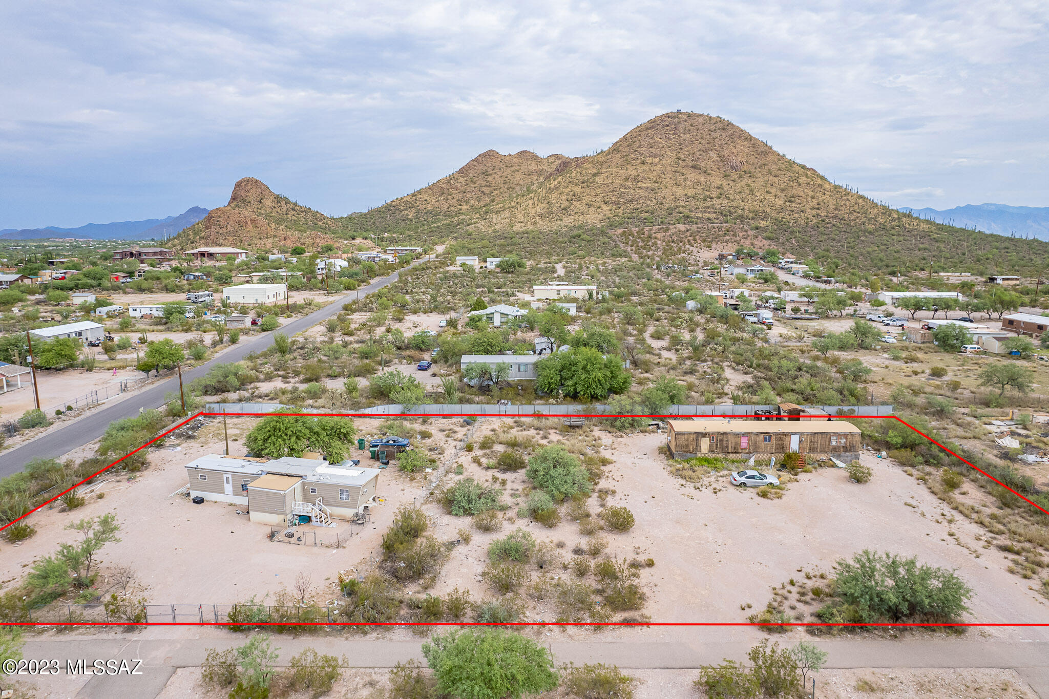 Prime 1.03 Acre Land with Stunning Mountain Views in Tucson's SW Side. Are you looking for your own slice of desert paradise with breathtaking mountain views in Tucson? Look no further! This piece of land offers the perfect canvas for your dreams of Arizona living. Zoned SH (Suburban Homestead), this property presents an incredible opportunity for both homeowners and investors alike. With  2 separate utility hookups this makes it an attractive choice for those looking to build a home with a guesthouse, or rent the space for two manufactured homes. Whether you're seeking a personal oasis or a smart investment opportunity, this land has the potential to turn your dreams into reality. Current homes are tenant owned and will not convey with the property.