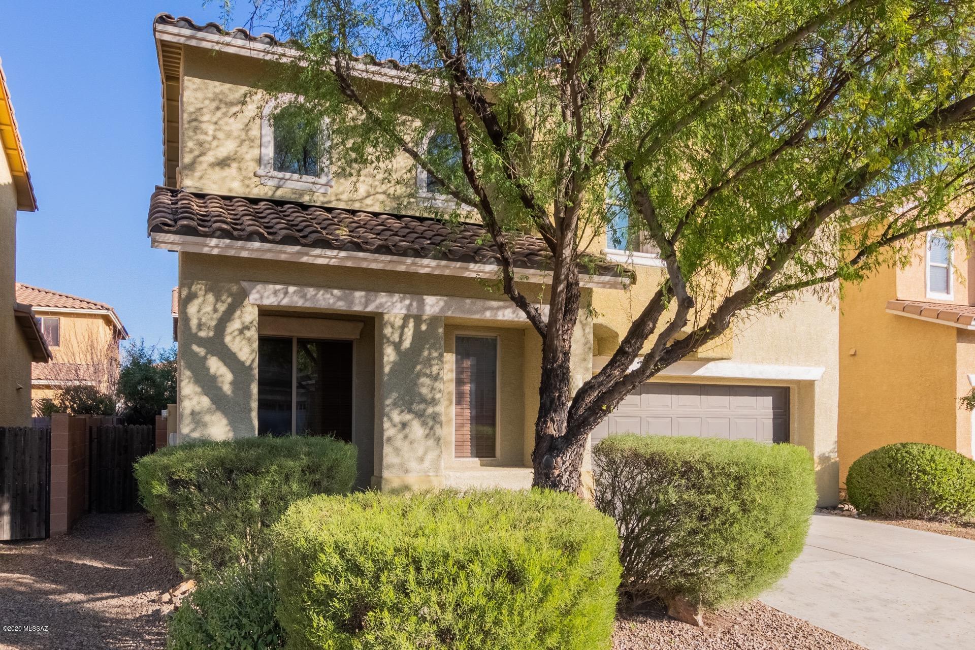 Beautiful two story, 4 bedroom north Tucson home available in highly desirable Paseo Del Rio. Excellent community, located just a couple of blocks from the Rillito River Loop, great schools, parks and multiple options for shopping, dining and entertainment. In addition this home is conveniently located minutes from I-10. Inside you will find an impressive living area with soaring vaulted ceilings. Beyond the spacious, open kitchen and dining area boast ss appliances, warm wood cabinetry and an island. Stylish custom paint tones throughout. Gorgeous diagonal tile flooring in all high traffic areas with light carpet in the bedrooms. Upstairs master retreat includes a private en suite with dual sinks and a separate soaking tub and shower. Secluded backyard is fully enclosed and offers a covered patio and mature trees.