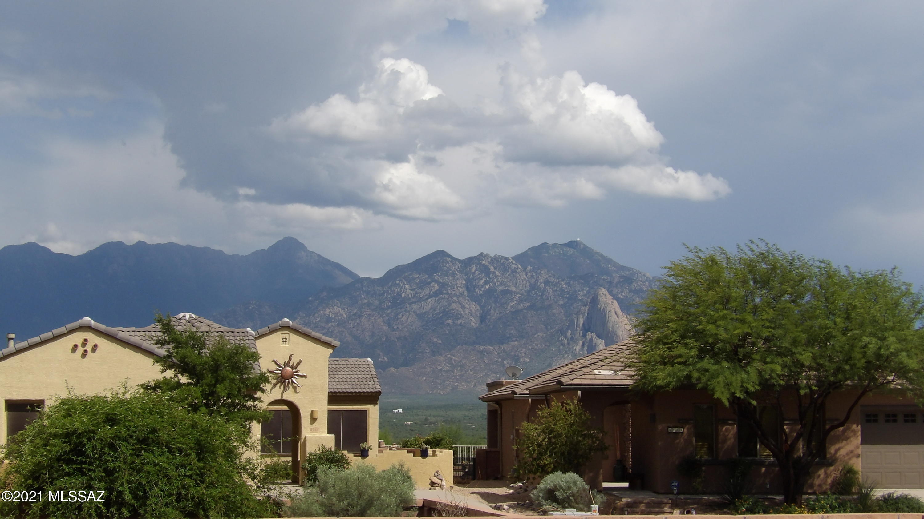 Beautiful Canoa Terrace Home with Mountain Views, GREAT ROOM,  3 Bedrooms, 2 Baths and an extended Garage. Tile/Carpet Floor,  Gas Range, 36''  Cabinets,   Ceiling Fans, Gas Stub Out for future BBQ,  Electronic Water Softener and many more features. Private Back Yard with some Views of the Santa Rita Mountains which would be Great for Entertaining. Gated Committee,  Must See.