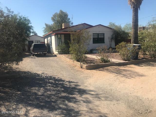 Bright and clean Bungalow home.  Main house features 2 bedrooms and 1 full bath.  Hardwood floors, with an Arizona Room off the Kitchen.  Guesthouse is a studio style and very private (currently rents for $630/mth and tenant would like to stay.  Large backyard with mature fruit trees and dog run. with access for an RV if desired.  Did I mention no HOA!!  Close to shopping, U of A and so much more.