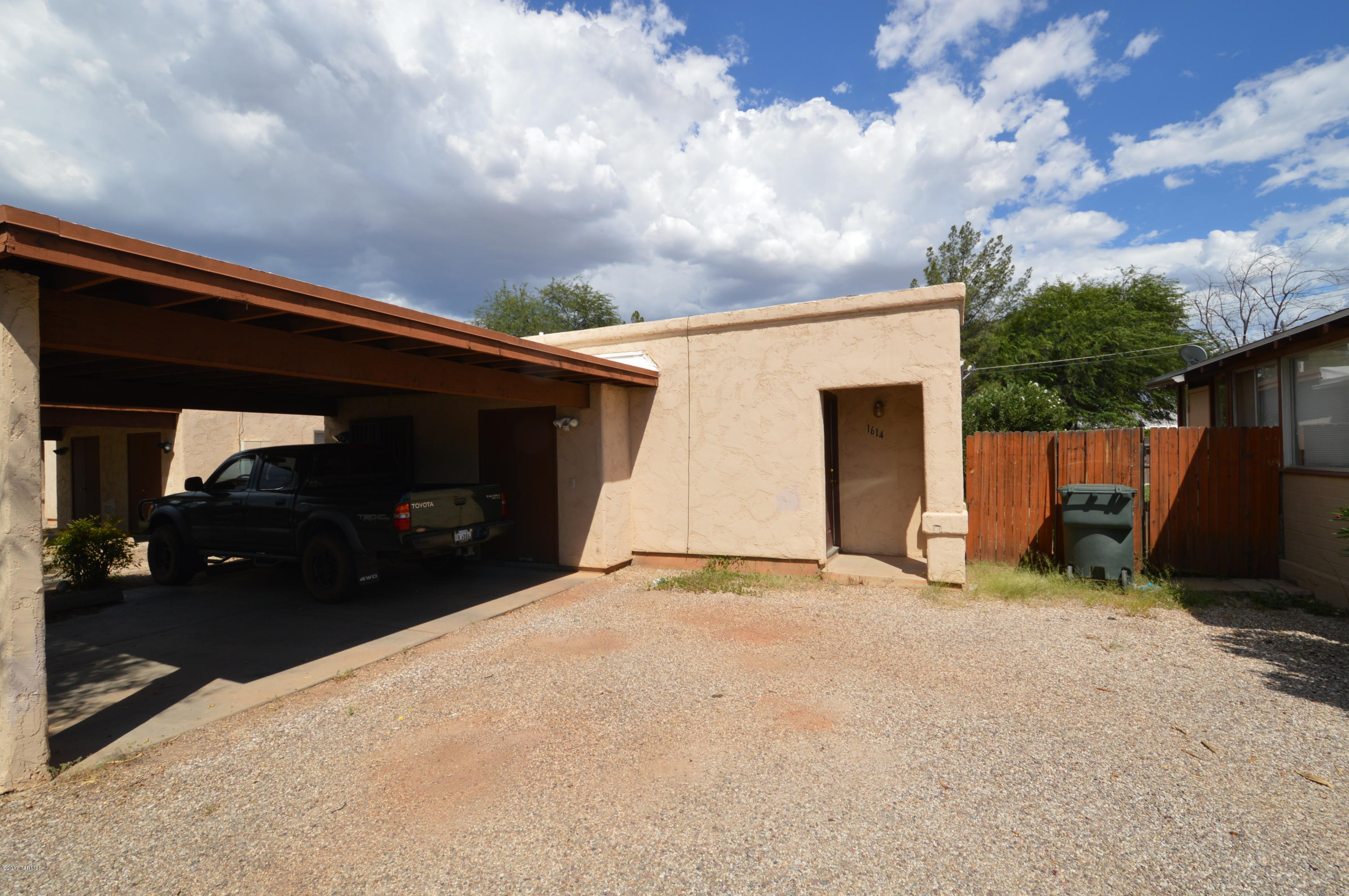 2 bedroom duplex. Large rooms, spacious and open floorplan. Well equipped kitchen with range and refrigerator. W/D hookups and water is paid by owner. Comfortably air conditioned with economic central heat pump. Large fenced yard with lots of room for entertaining. Includes one carport space and a storage room. Quiet, comfortable and easy access to everything. CALL TODAY!!  Description & photos may be for similar unit in complex.