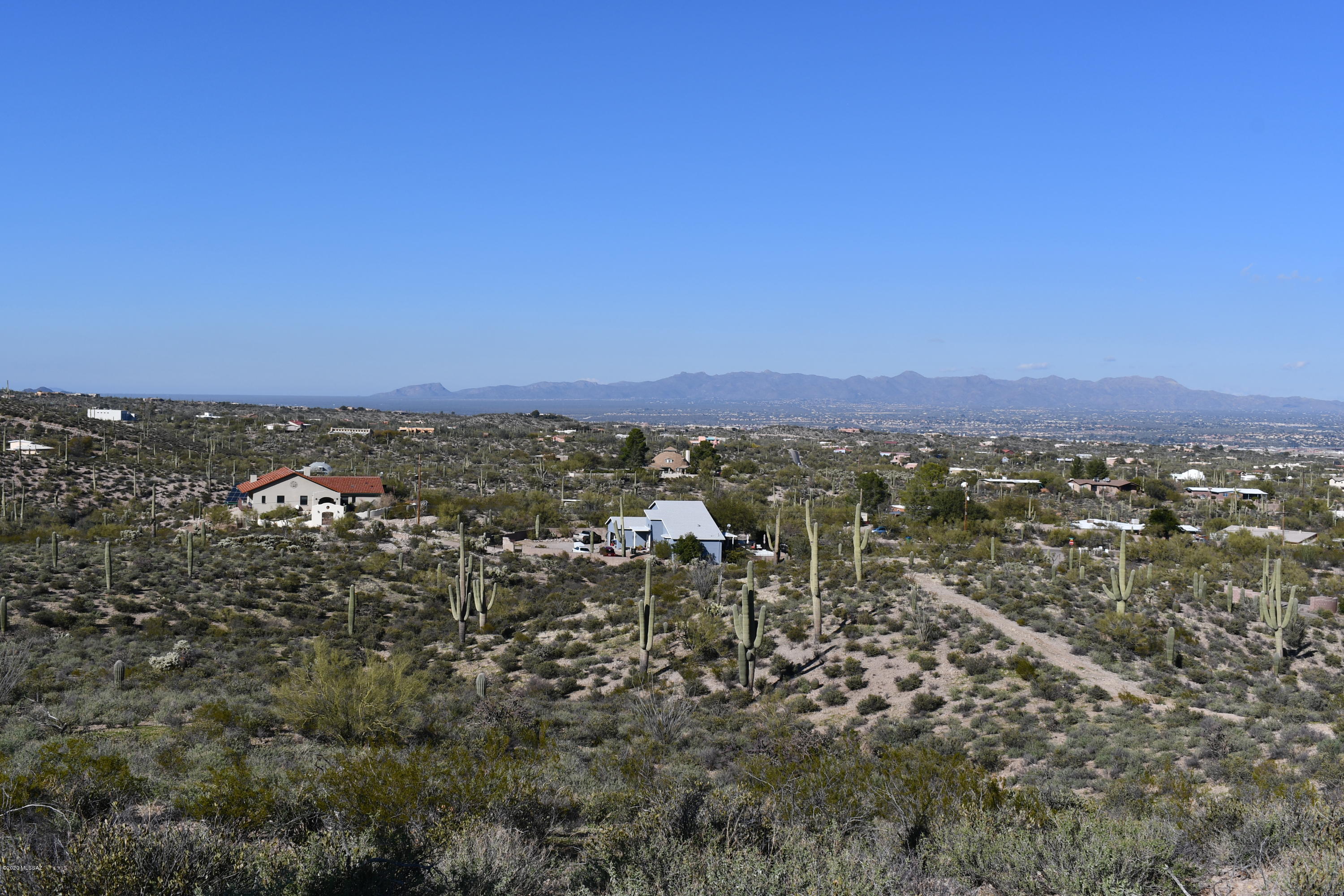 Spectacular city and mountain views from high perch in the Tucson Mountains. Private gated road, easy access to downtown and I-10. Around the clock views, mature natural vegetation. Underground water, electric and phone. City of Tucson water Meter included! Terrific custom home site, seller offering owner finance for 3 to 5 years with 20% down payment.