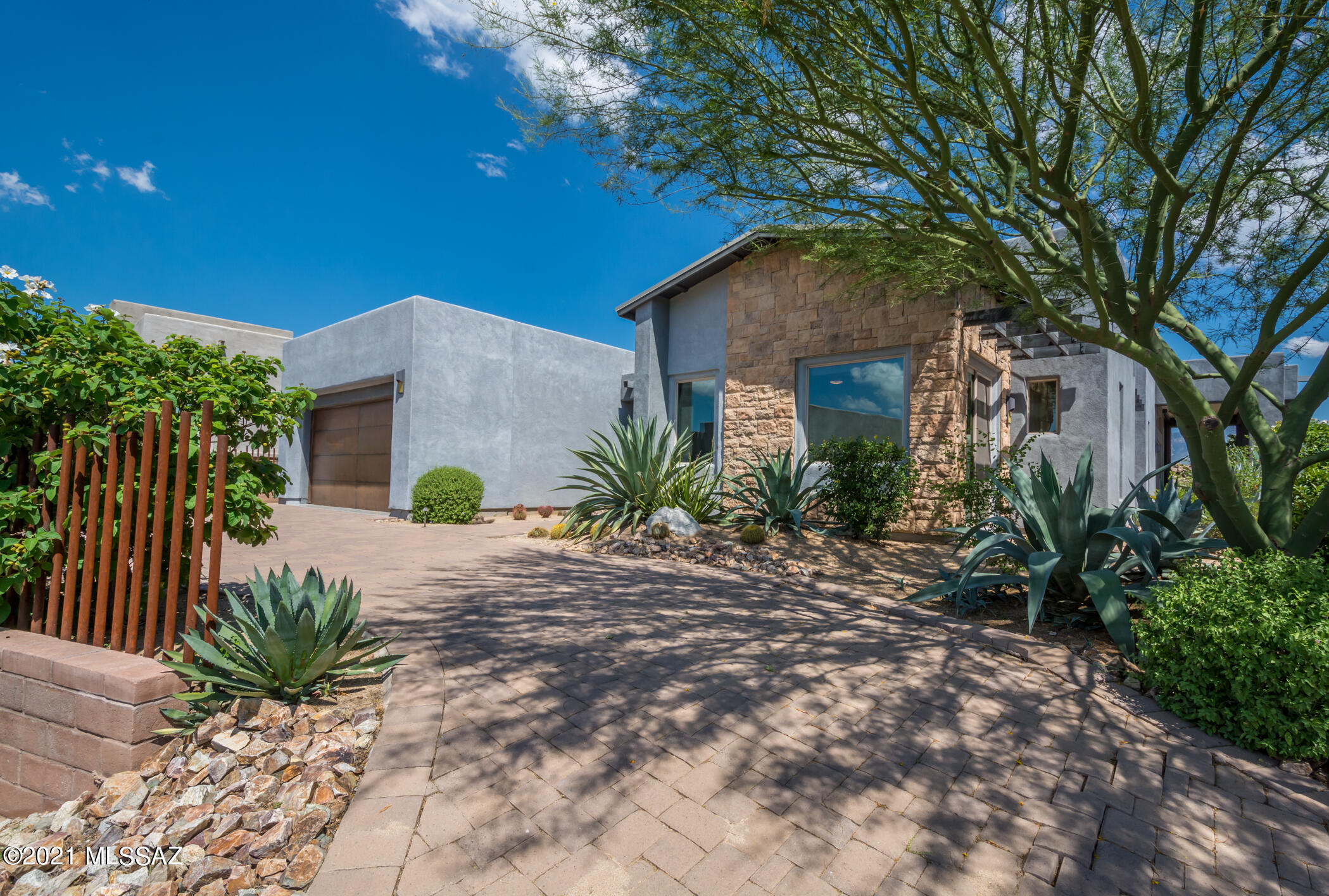 Premier location in the Enclave at Stone Canyon within walking distance of the Stone Canyon Health and Fitness Center, Golf Course, and Clubhouse. Shows like a model with views as good as they get! Large rock formations, giant saguaros, and gorgeous Catalina Mountains. Gourmet kitchen boasts large island w/seating, Silestone countertops, designer cabinetry, Kitchen Aid appliances, and walk in pantry. Double masters with den (could be three bedrooms). Crestron home automation, built-in BBQ, fire pit, motorized solar shades, Custom cabinetry with accent lighting in great room. Whole house window tinting for energy efficiency. Three car garage (tandem).