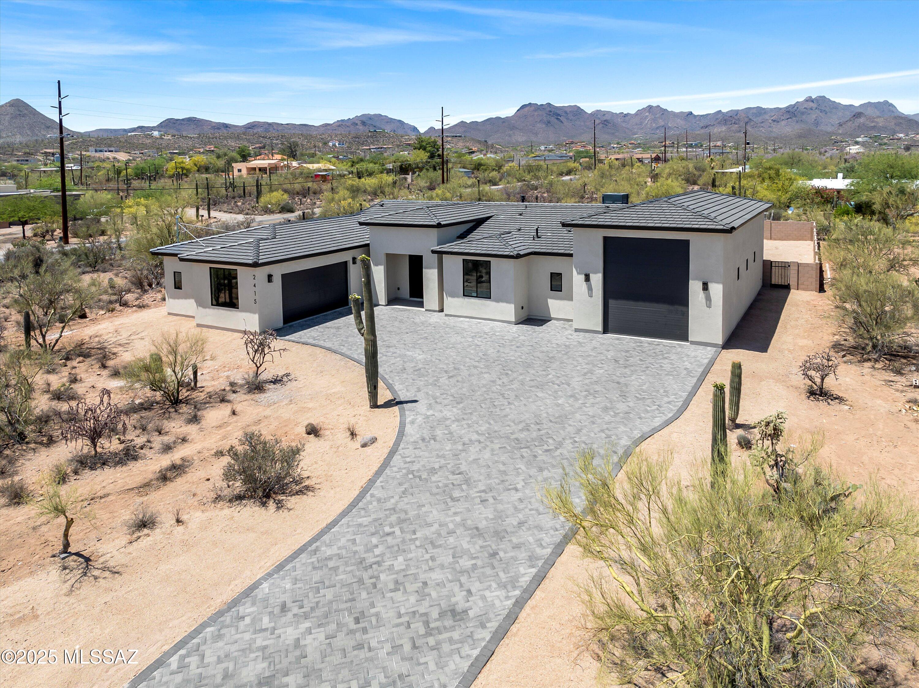 Welcome to this stunning new construction contemporary masterpiece, offering the perfect blend of luxury, design, and functionality. Centrally located with spectacular views and easy access to I-10, downtown and shopping centers. Spanning an expansive 3,000 SF, this home is thoughtfully designed with 4bed/4bath plus office room. Walk into the chef's kitchen which is a true showstopper with custom made cabinets, built out pantry, seven burner gas range, a massive quartzite island, while the living room centers around a cozy gas fireplace. Retreat to the spacious master suite, which showcases a private exit to the back patio, along with a spa-like ensuite bathroom. Dual sinks, an oversized glass-enclosed walk-in shower, deep soaking tub, and dual walk-in closets, A must see!