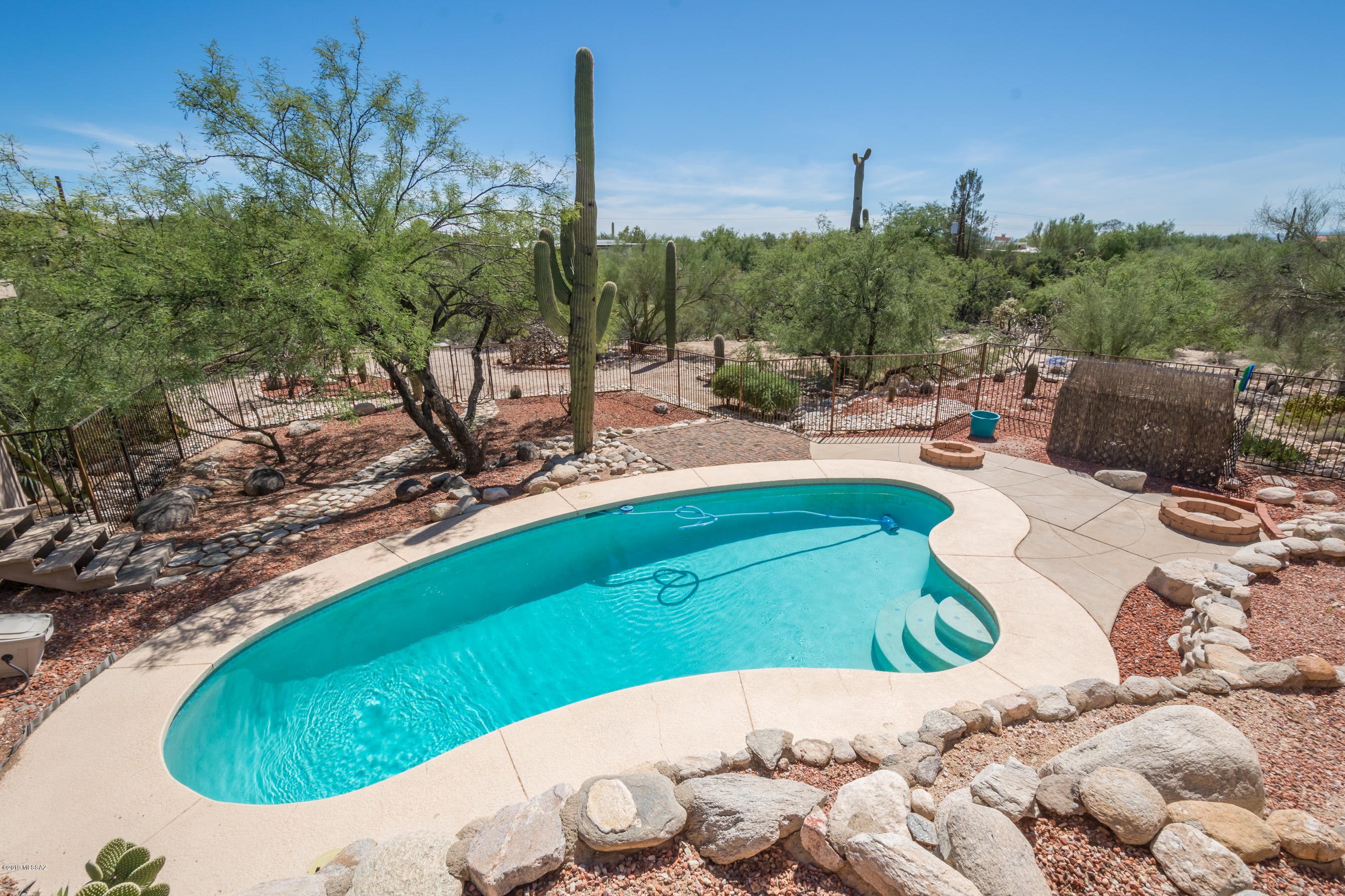 This lovely updated Foothills home is nestled on a quiet .98-acre cul-de-sac lot and features nice mountain views, gorgeous remodeled open kitchen with elegant cabinets, glass fronts, pull outs, Corian counters, stainless steel appliances & stunning wood floors. Other features include spacious living room w/large picture windows and fireplace, split floorplan, master suite with 2 pedestal sinks, separate shower & tub. Walk out the kitchen slider to the private terraced backyard w/tons of character, sparkling pool, low care desert landscaping with saguaros plus storage/workshop. Cross the patio to the large bonus room with ¾ bath, ideal for guest quarters, office, studio, man cave, etc. Terrific neighborhood close to awesome shopping, dining, schools and an easy commute to U of A & downtow