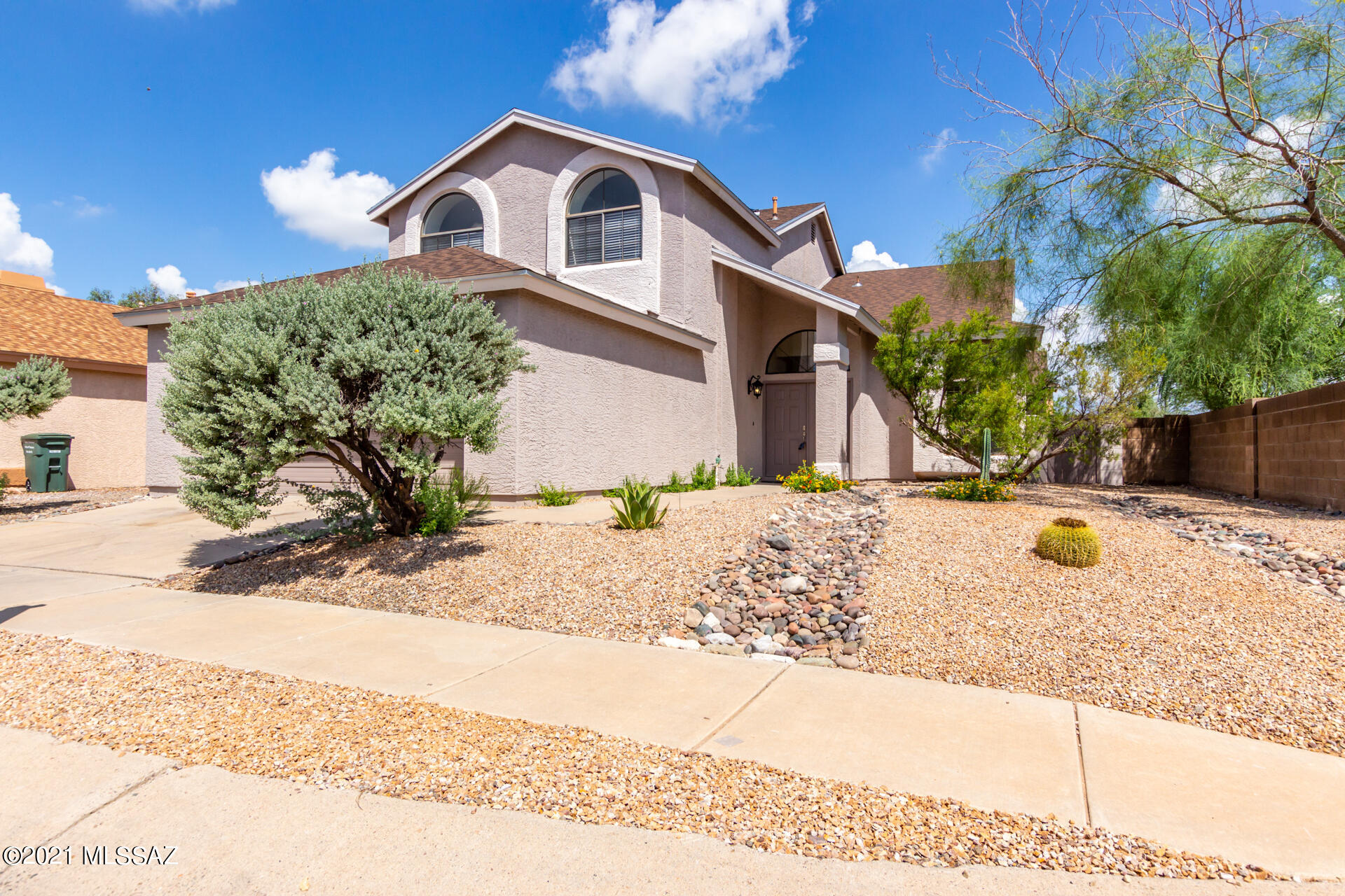 Seller will accept or counter offers between $409-419,000. Hidden away in the quiet & little-known gated community of Desert Cove, this spacious newly & completely remodeled home boasts spectacular views of the Catalinas and Rincons from the spacious 2nd story deck from the large Master Bedroom Suite w Walk-In Closet & separate deep tub & shower. Bay windows & seats in every bedroom, a cozy fireplace, and vaulted ceilings accentuate this versatile split floor plan featuring 3 bedrooms & 2 full bathrooms upstairs & a large bedroom and full bathroom downstairs, perfect for office, teen, or mother-in-law. 2 car garage w extra landing and automatic opener. The well-maintained park with a huge pool invite. The house lies adjacent to Case Natural Park, take a nature hike right out your front door onto land never to be developed. All new appliances & roof.