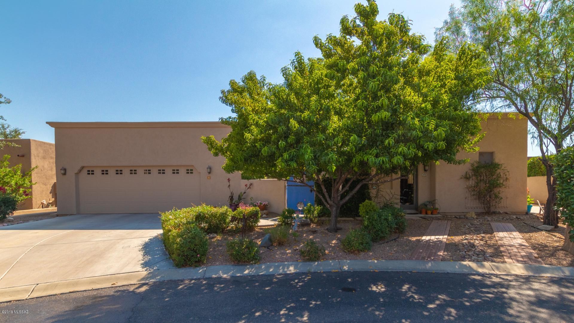 Beautiful semi custom Dorn home.  1916 sq/ft 2BR, 2.5 BA main home and 497 sq/ft guest Casita ).  Private gated front courtyard w/wall fountain, lush landscape and skydeck w/straight stairs (additional storage under stairs).   Ceramic tile flooring in all main areas, beehive gas fireplace, wood beam ceilings, Anderson doors/windows,  Alder int doors.  Kitchen granite countertops, new LG appliances, dual sink, alder cabs, built in oven/microwave  & eat in area. Large master BR w/door to rear patio.  Dual vanity,tub,shower  & walk in closet in MB.  Bedroom 2 w/Murphy bed and full bath, can be office/den.  Large rear east facing covered patio backs to a large common area.    Guest Casita - gas log beehive fireplace, built in cabinet w/sink, refrigerator, microwave area, & private patio! Don't hesitate on this luxurious home! Book your showing today! This gem is most definitely sure to impress!