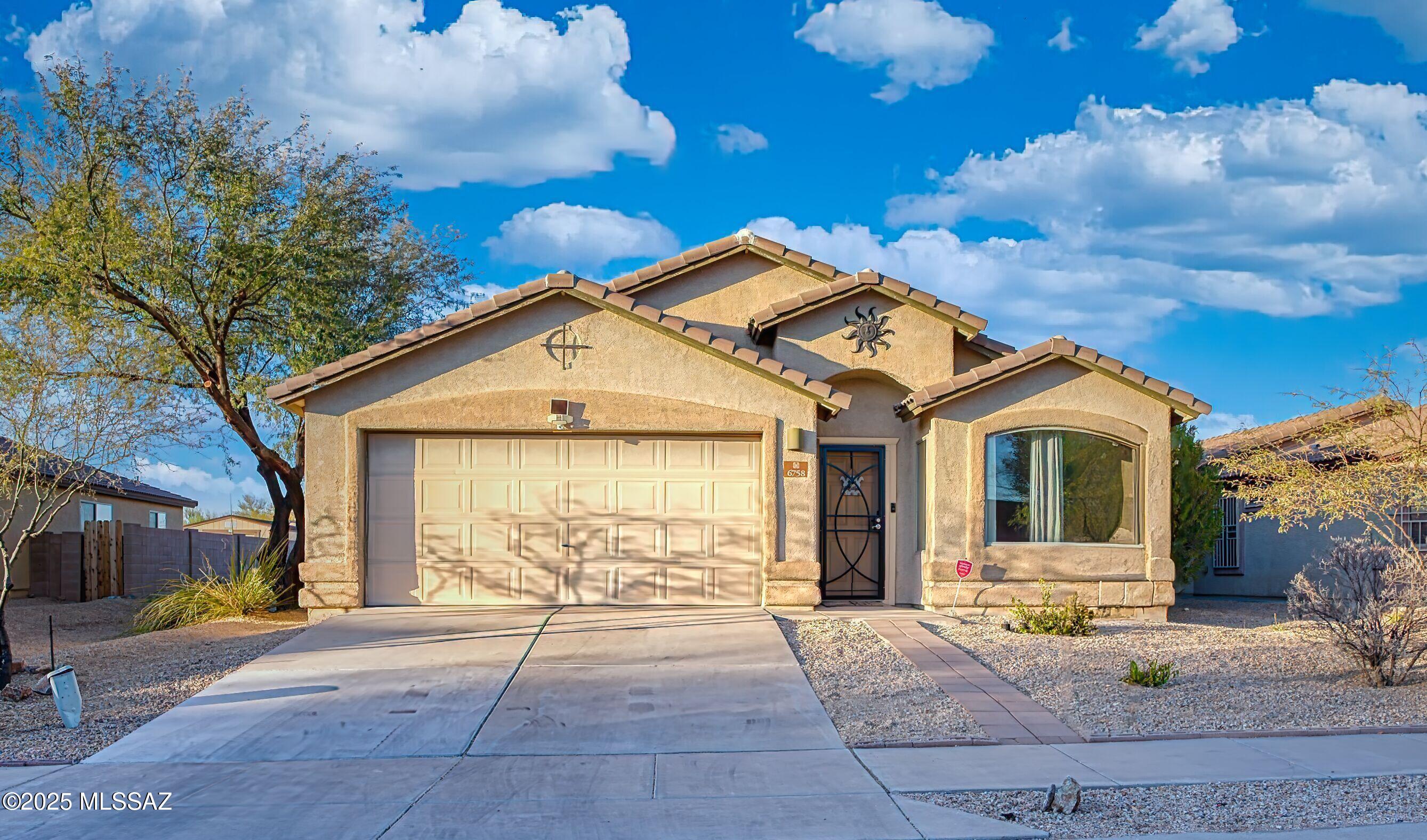 Welcome to this beautiful home! This beautiful home includes vaulted ceilings. Walking into the home you are greeted into a spacious living room. Following into an open floor plan kitchen with a beautiful island, kitchen has granite counter tops, dining area, and great room. This home features 4 bedrooms, 2 bath, jack & jill is a bonus, with tile flooring and carpet throughout the bedrooms. Enjoy the outdoor with a covered patio, a private backyard from surrounded neighbors. Minutes away from I-19/I-10, shopping centers, nearby parks and schools. Don't miss out on this amazing property!!!