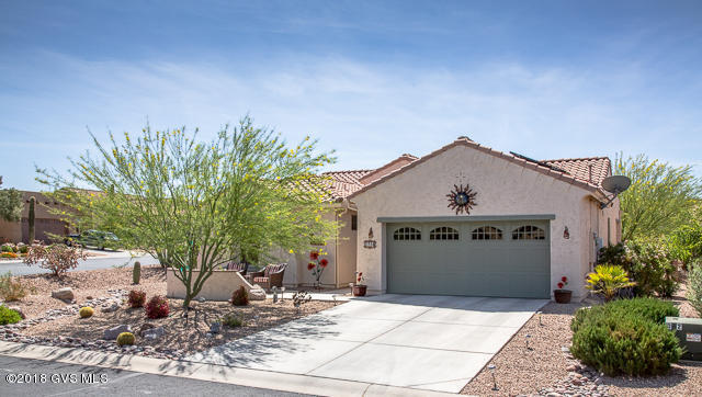 Baja model with a 4 Ft. EXTENDED Garage & an OWNED solar system  LOW Electric bills! 1,609 sq. ft. home with security screen door at entry. 2 BR's, 2 Baths & Den with Privacy Doors (can be 2nd Guest Room). Master BR has Bay window extension. 18-inch tile on the diagonal in all but bedrooms, which have new carpet (2016). Kitchen has Granite Counters, touch-faucet at sink, Reverse Osmosis, Alder 42-inch height Cabinets, Extra Drawers in Kitchen Island, Pull-outs in lower cabinets & Pantry, New SS 2016 GE Profile Refrigerator, Double oven smooth-top range & dishwasher. Baths have Rain Glass Shower Doors, Assist Bars in Shower and Comfort Height Toilets. Cabinets above New 2017 Top-load, LG Washer (SS tub) & Dryer in Utility Room. 4 Foot GARAGE EXTENSION and Epoxy Floor Coating.  Over-head storage racks included. New QUIET Garage Door Opener 2017. Extra insulation in garage attic. New Water Softener (2017). Fenced in Backyard that backs up to an Arroyo. Extended Patio with Hot Tub & BBQ Grill   both convey with house. 2014 Golf Cart also included! TEP Energy Star Home. Exterior painted 2016. Gutters. Close to all the amenities Quail Creek Country Club has to offer. View this house and make it your new home!