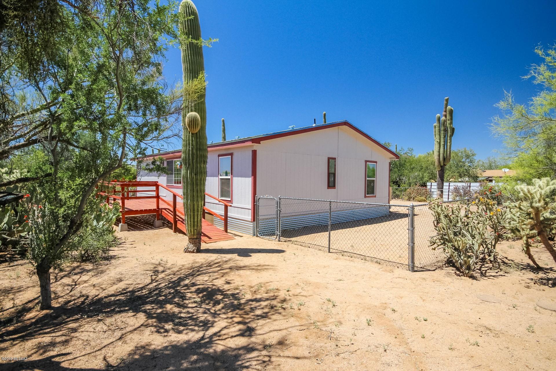 Step inside this magnificent manufactured home available on an acre of gorgeous property ideally located in extended West Tucson. Love life while enjoying the serenity of wide open spaces and breathtaking desert views. Enter into your spacious great room perfect for entertaining! The neutral color scheme of the home will magnify your belongs from the start! Spacious living area features beautiful wood style flooring. Cook a great meal in your stylish kitchen that boasts crisp white cabinetry and stainless steel appliances! Retreat to your huge master en suite with dual sinks in the master bath! Enjoy two additional bedrooms perfect for guest or an office! Enjoy your backyard overlooking your own personal desert oasis!