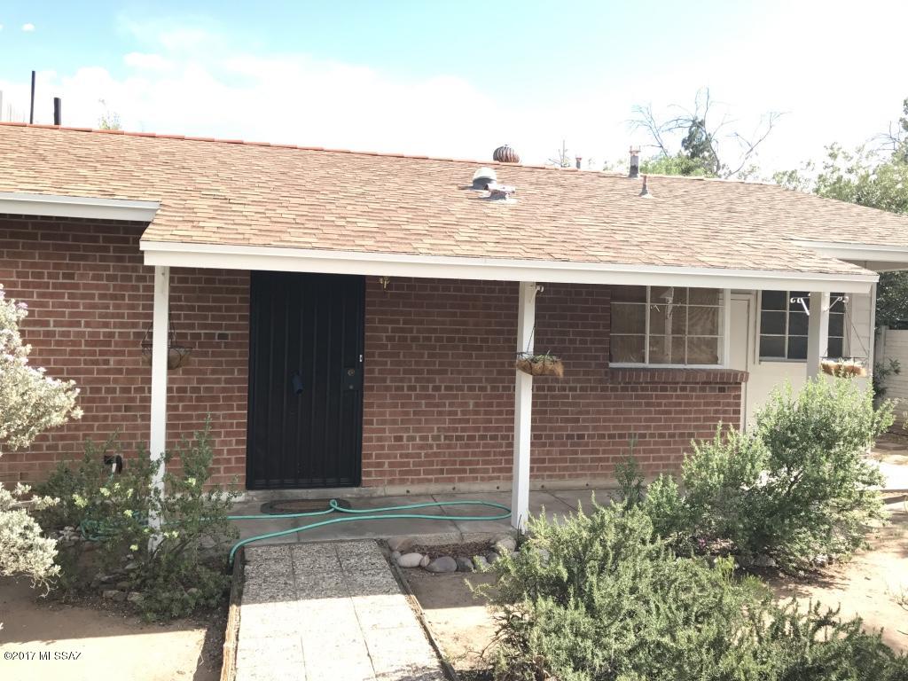 Charming red brick home in central location, less than 5 miles from University of Arizona and University Medical Center. This home features a large living room, formal dining room, and workshop or storage area off the kitchen. Includes a large backyard with mature fruit trees and two garden sheds that offer plenty of storage.