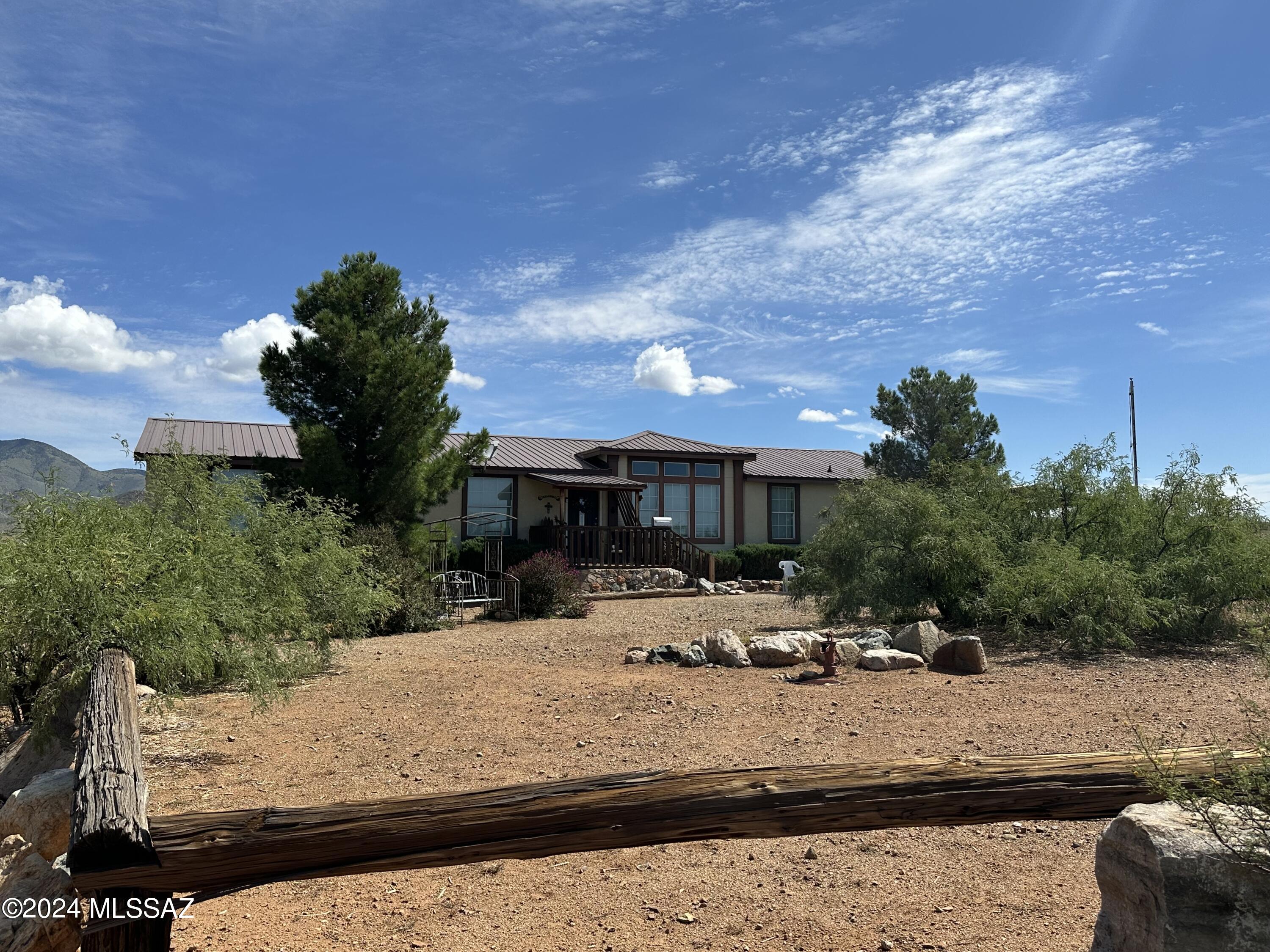 This large custom built home that was designed by the seller has three bedrooms, three bathrooms a large eat in kitchen, family room and living room. Every aspect of this home has been up-graded. Covered back and front porches, large Mueller Metal workshop with electric, heating and cooling.  Horse facilities, round pen and some corrals and 37 completely fenced and crossed fenced acres. Private well with excellent water.
