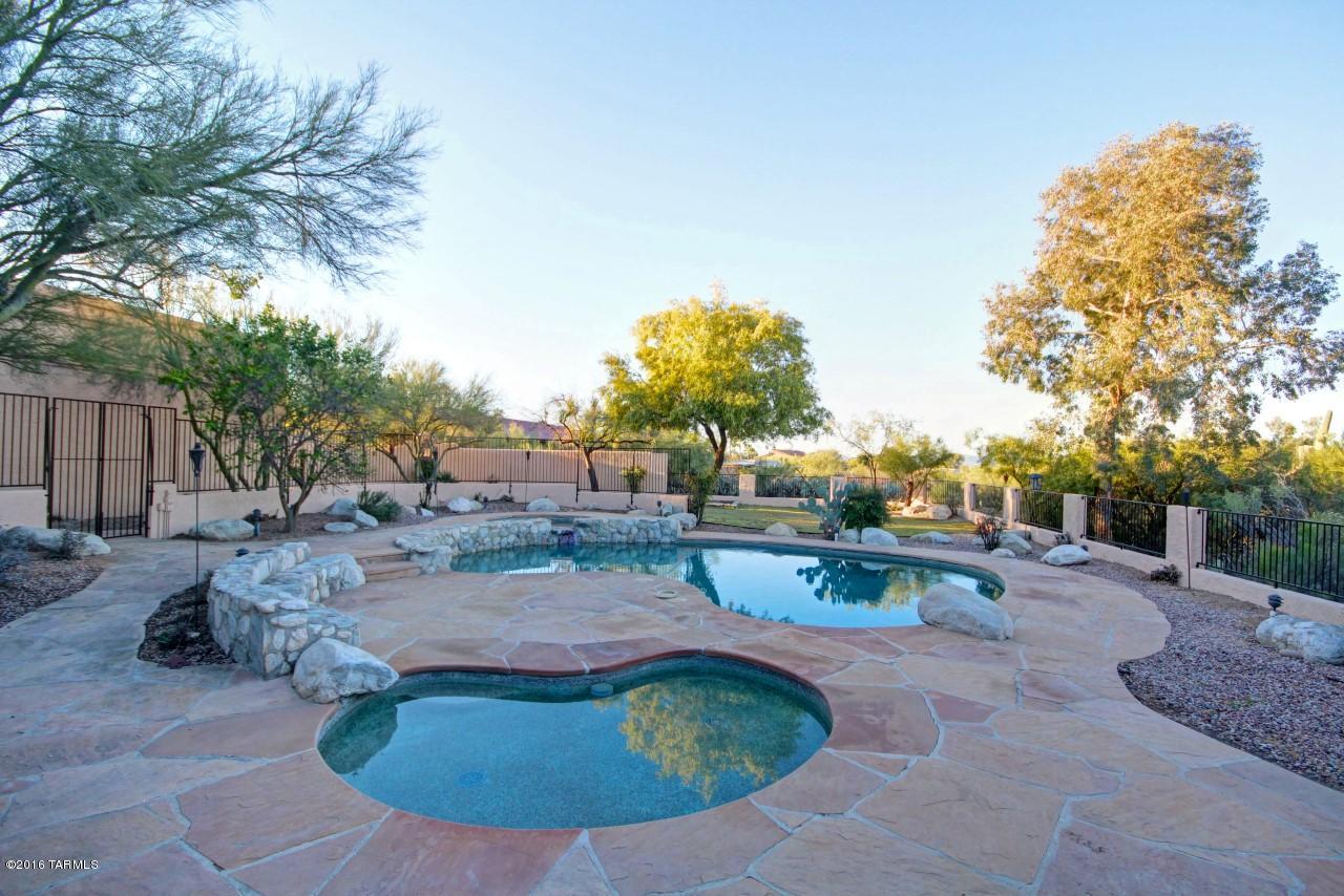 Beautifully remodeled custom home in District 16! Located in quiet cul-de-sac in desirable Shadow Hills. New paint inside and out, refinished hardwood floors with travertine tile, new carpet and stainless steel appliances. Resort like back yard with nice pool, wading pool and spa! Enjoy the outdoors in this fabulous setting, patio area, ramada w pool table, bbq area with built in BBQ, fire pit and lots of room for a playground, bball hoop, etc, perfect for entertaining. The inside features a warm and inviting floorplan,formal living and dining, kitchen with island, upstairs loft, oversized bedrooms each with balcony access. Huge walk deck over the garage with beautiful city and mountain views. Extra storage in expanded garage. One of owners is a licensed RE broker in AZ.