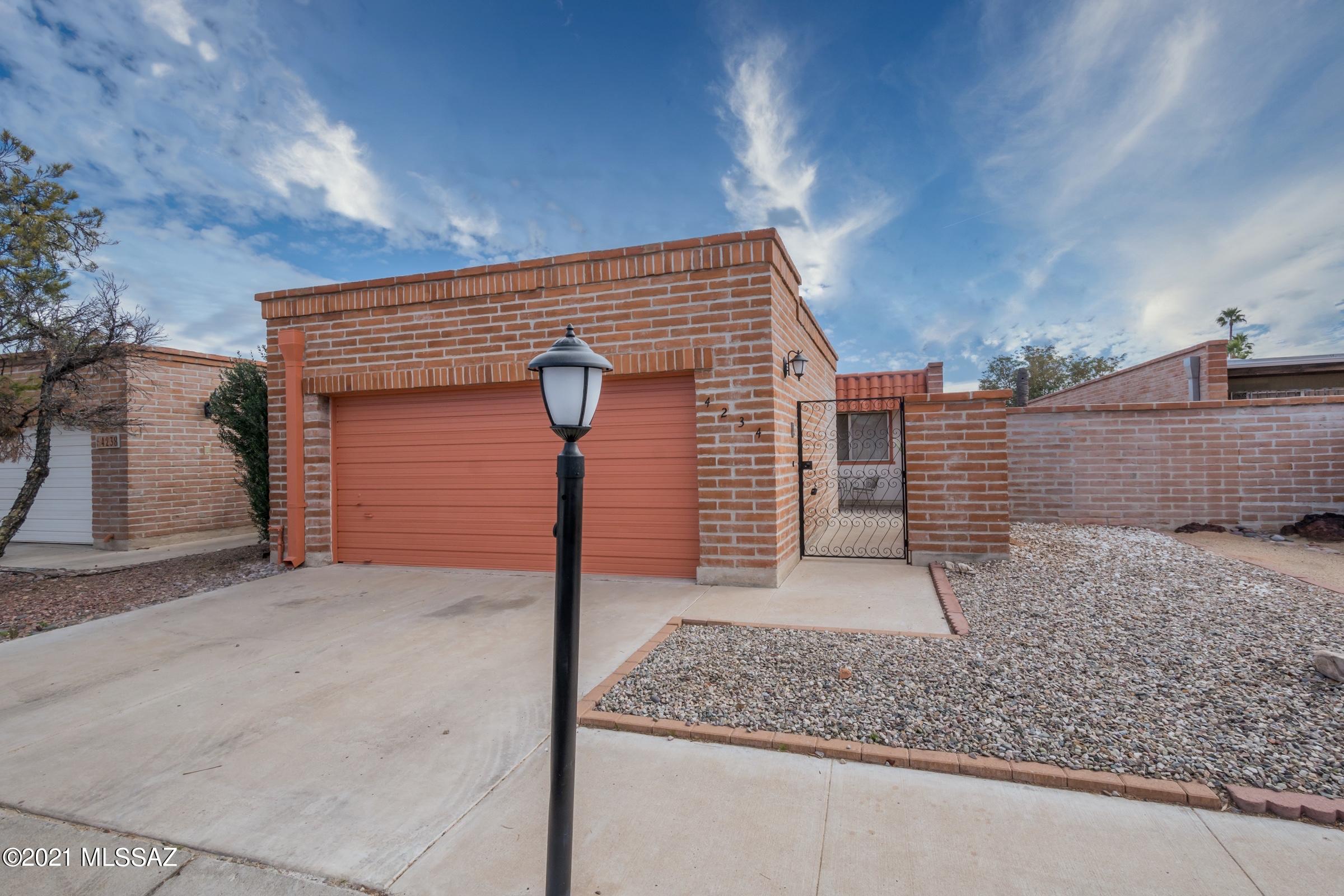 Don't miss this fabulous 2 bedroom + den townhouse tucked in on a tree-lined drive close to Tucson Mall & Limberlost Park! The gated courtyard entry welcomes you into the foyer with spacious living & dining areas beyond. Generous kitchen offers tons of cabinets, breakfast nook & a brand new extra long kitchen counter. Large format ceramic tile leads through the French doors into the family/AZ room. Backyard offers a covered patio with a peek of the mountains and the circular staircase takes you up to bigger views from the roof! Large master bedroom with updated ensuite bath & walk-in shower, additional second bedroom plus nicely upgraded full guest bathroom. Solid Wilford built construction, 2 car garage & community pool! Rentals are not allowed per CC&Rs.
