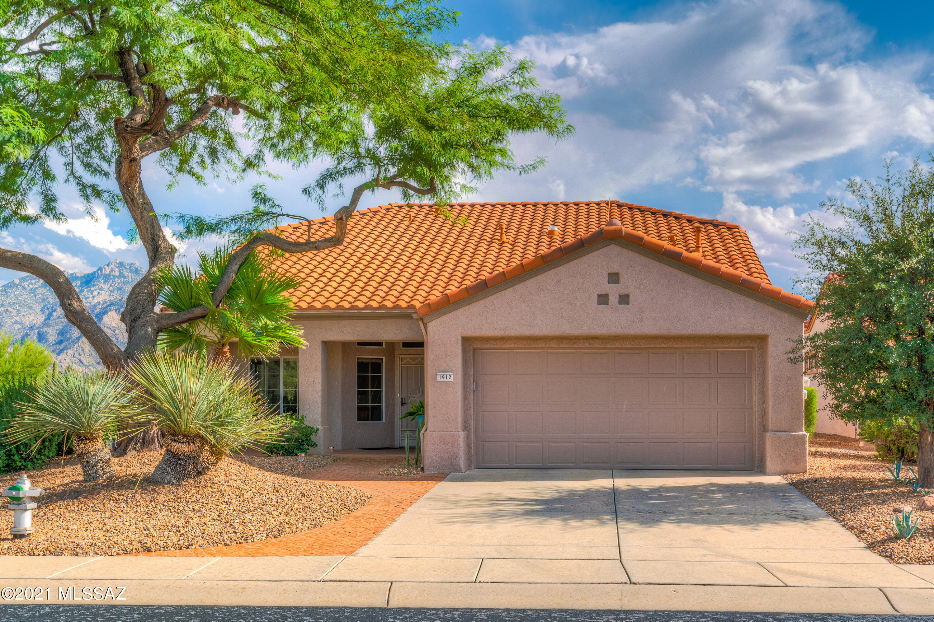 Stunning 3BD/2BA (1,665 SF) Whitehall plan on large corner cul-de-sac lot in Sun City Oro Valley boasts majestic side & rear Catalina views! Gorgeous upgraded tile in heavy traffic areas you must see to appreciate. High ceilings throughout! Two separate living areas. Both bathrooms full of elegant upgrades! Bedroom closets feature custom built-in storage. Third bedroom used as office. Garage houses laundry w/utility sink, loads of storage, workbench and convenient side door. Unwind on private patio overlooking professionally landscaped backyard featuring two awnings, gas hook-up for grill, plus lush shrubs & plants. All on sprinkler/drip! Rec center nearby. Sun City active adult community offers clubhouse-golf course-fitness center-pool & more. *Home has solar lease* This is a hidden gem!