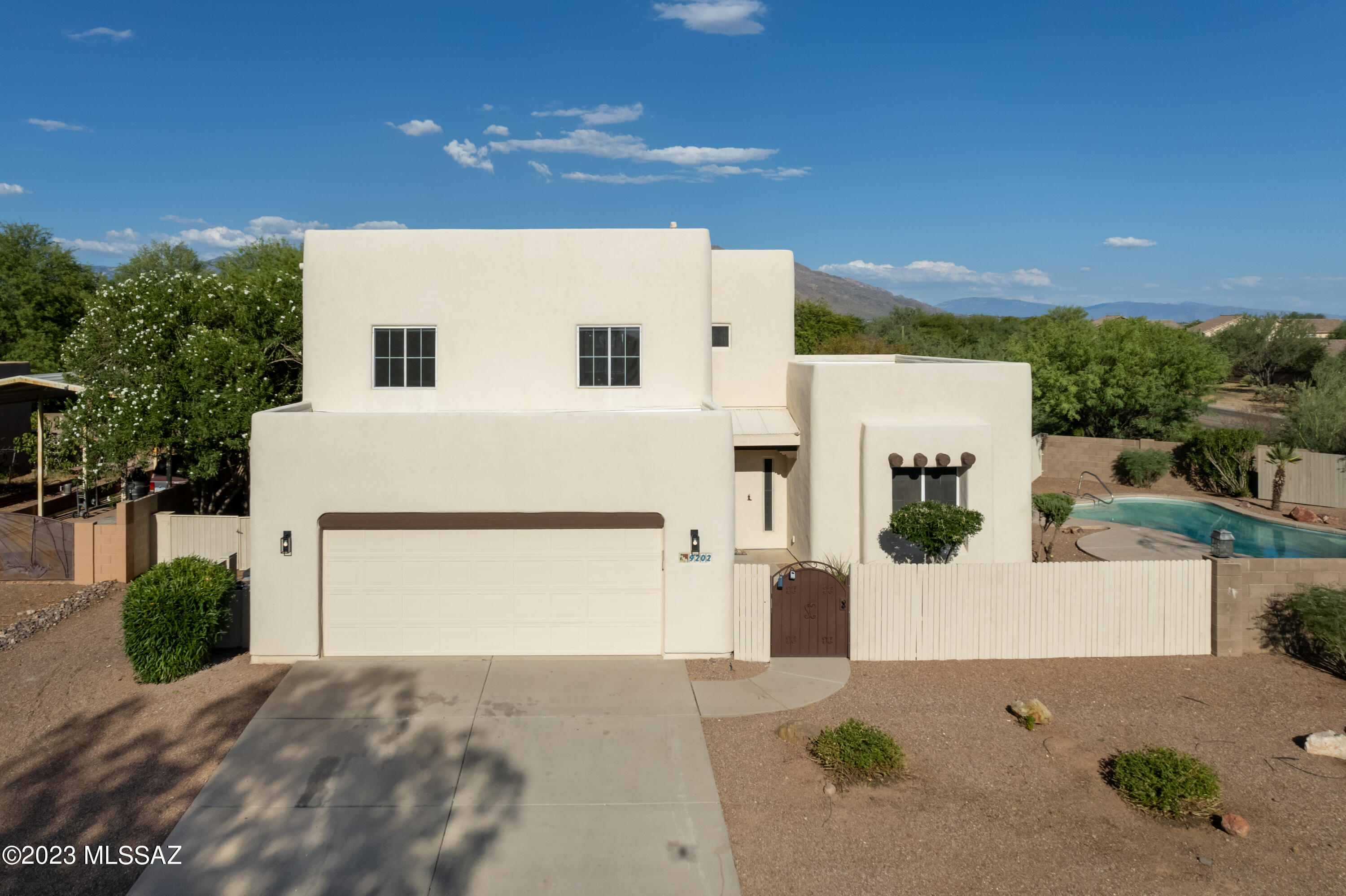 Welcome to your dream home in the heart of Northwest Tucson! This stunning Santa Fe style residence showcases the perfect blend of Southwest charm and modern elegance. With breathtaking mountain views and a sparkling pool, this 4-bedroom, 3-bathroom home offers an exceptional living experience. Move inside and be captivated by the spaciousness and warmth of this meticulously remodeled Home. The main level boasts a thoughtfully designed floor plan, featuring a living room, dining room, stylish kitchen, plus a bedroom and full bathroom, providing convenience and versatility for guests or multigenerational living. In the heart of the home, the kitchen, you will love the all-new stainless-steel appliances, quartz countertop, tile backsplash, updated cabinets, and spacious pantry. The true gem of this home awaits you upstairs - a sprawling Ensuite that defines luxury living. Pamper yourself in the grandeur of the massive bedroom plus your own spa-like bathroom. If you need more, you have your own private deck offering awe-inspiring vistas of the surrounding mountains. Wake up to breathtaking sunrises and unwind with mesmerizing sunsets - all from the privacy and comfort of your own sanctuary. Every corner of this home reflects meticulous attention to detail. The recent remodel has seamlessly combined modern upgrades with the timeless Santa Fe architectural style, creating a harmonious and inviting ambiance throughout.
Outside, embrace the serenity of the desert landscape and the true essence of Santa Fe living. The inviting pool beckons you to cool off during the hot summer days while the picturesque mountain views provide a backdrop of tranquility. All this home offers easy access to local amenities, shopping, dining, and recreational activities. Don't miss the opportunity to make this Santa Fe oasis your own. Come and experience the beauty, comfort, and lifestyle this remarkable home has to offer. Schedule your private tour today and prepare to fall in love!!