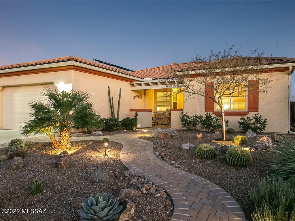 Rare opportunity to purchase a beautifully FURNISHED home with gorgeous mountain views! This beautiful open floor plan home features mountain views from the great room, kitchen, dining area and owner's suite. The large kitchen boasts beautiful wood cabinets, granite countertops, stainless steel appliances and a peninsula counter with a breakfast bar. Upgraded tile with the exception of the bedrooms which have new carpet. The large owner's suite features a large open shower, a walk-in closet and has its own access to the backyard oasis . Relax in the picturesque outdoor living areas, from the front courtyard to the covered patio with a Ramada and stunning mountain views. Enjoy the sounds of the waterfall while you cozy up to the outdoor fireplace. Additional outdoor features... include ceiling fans, a pond and a retracting solar screen. A large two car extended depth garage offers additional overhead storage and built-in cabinets. All furnishings included in sale including the washer and dryer. Just bring your luggage and you'll be ready to enjoy all that Green Valley has to offer!