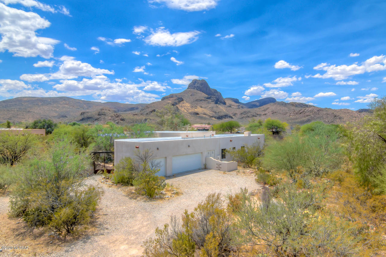 ***MOVE IN READY*** 3br/3ba home is an entertainer's dream full of character and charm! Located on over an acre with breathtaking mountain views and gorgeous custom features that give this home a ranch resort feel. Custom wrought iron gate entrances into the front courtyard and rear yard. Flagstone flooring throughout all living spaces with a large, open floor plan along with high ceilings and custom masonry touches. Large kitchen with custom cabinets and an abundance of storage. 2 cozy fireplaces with one in the master which includes his and hers closets and a large master bath with jacuzzi tub. Oversized bedrooms along with tasteful painting throughout the home. Rear yard has a large covered patio with access off the master. 3 car garage. Central vac installed and HOA includes garbage pickup.