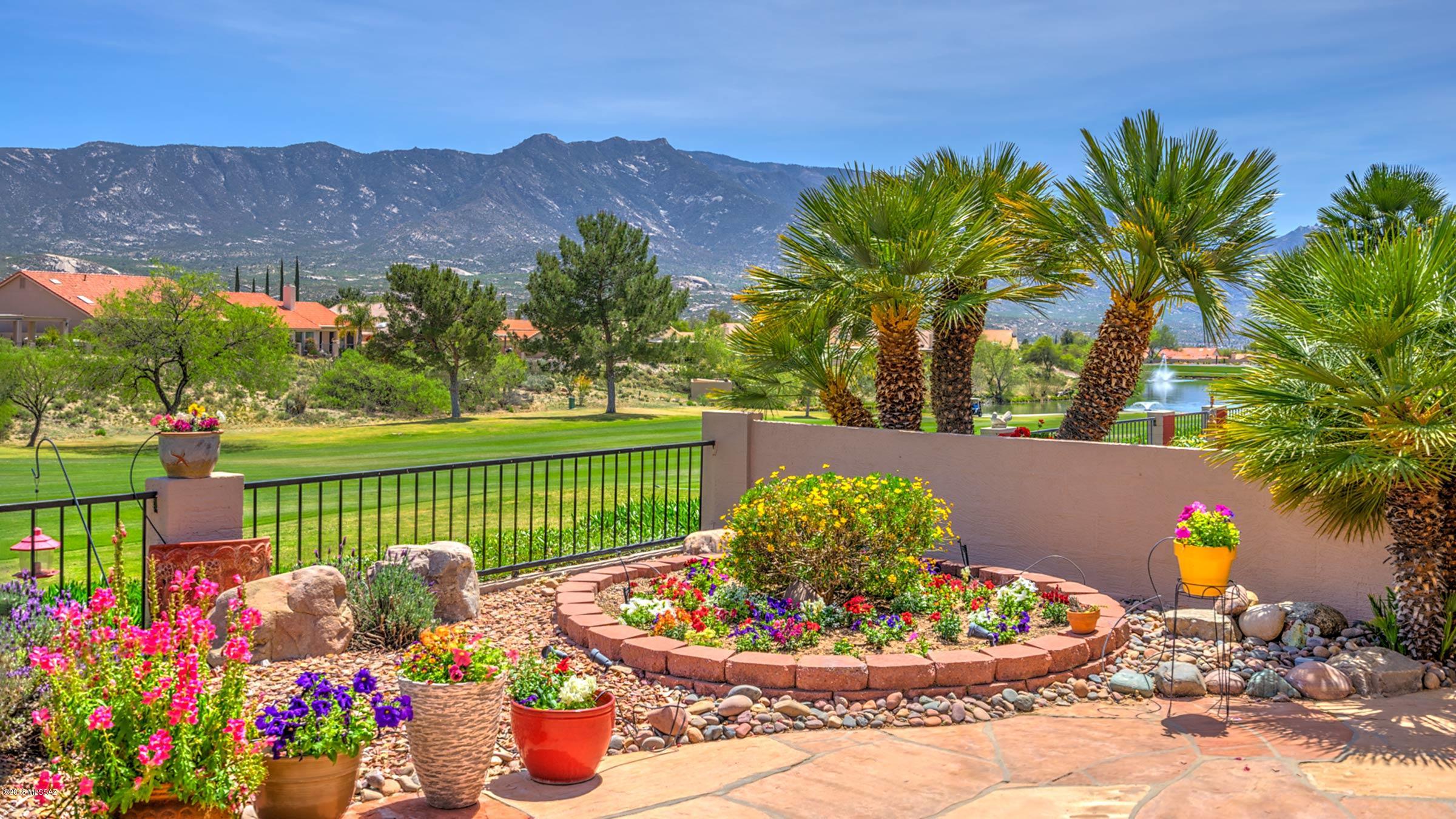 High above the fairway, enjoy stunning golf course, lake & mountain views from this highly modified Topaz model. Spacious great room & formal dining area overlook the view w/easy access to the covered patio. Updated kitchen is open to the great room & features new stainless appliances + plenty of cabinetry & counter space & is open to nook w/bay window. Master suite has updated en-suite w/dual sinks, shower, walk-in closet plus additional closet in the master bedroom. Two guest rooms & guest bath are perfect. Ceramic tile throughout, plantation shutters on most windows, large laundry/hobby room, + golf cart garage. The extended patio w/ built-in BBQ is ideal for all your entertaining needs w/extended flagstone patio overlooking the views or just enjoying the best of SaddleBrooke.