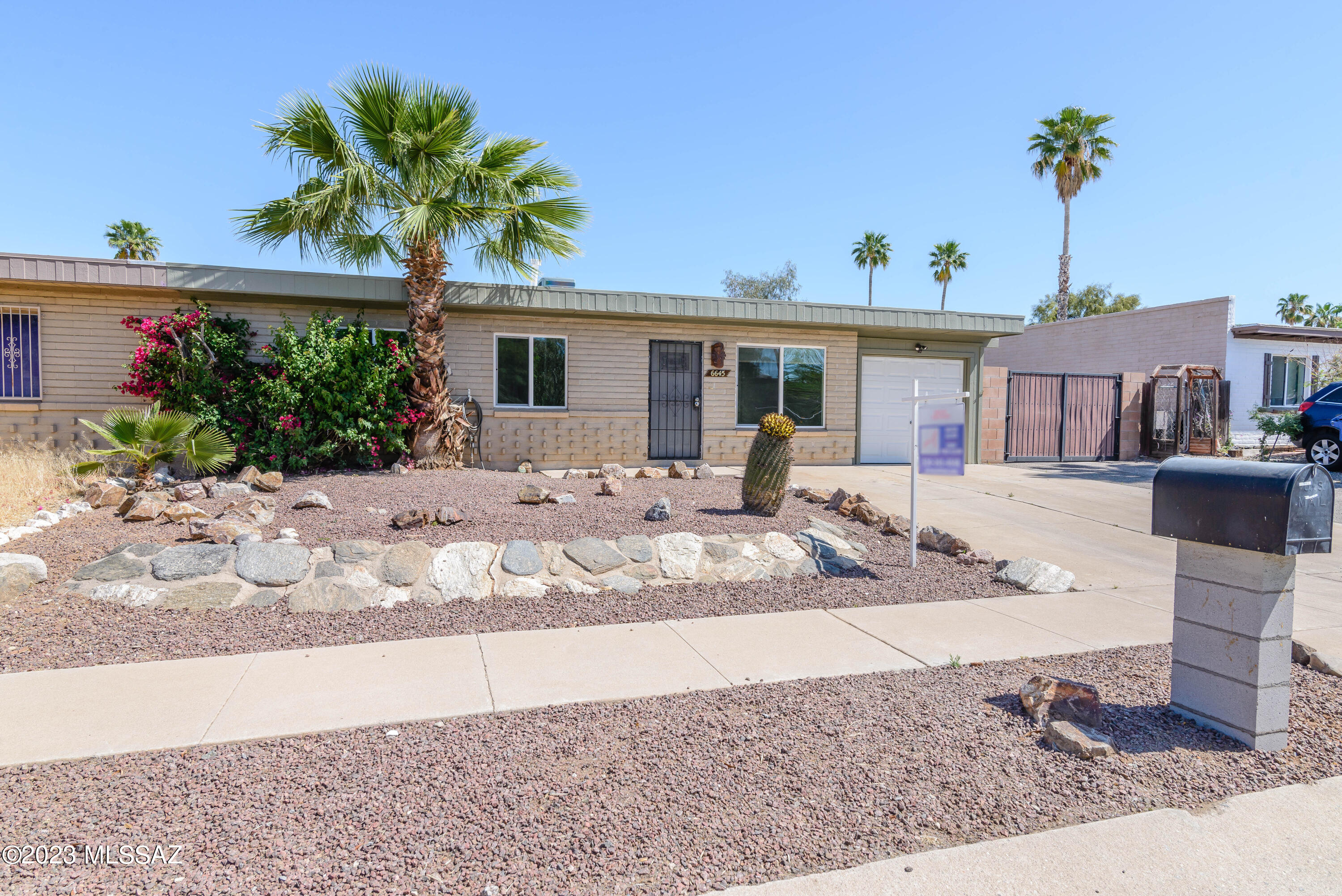 This adorably updated eastside townhome close to DMAFB offers tile and wood laminate throughout (not carpet), spectacular mountain views, updated bath and kitchen, with pantry. Plus laundry room with storage and garage and additional uncovered parking space. Don't let the square footage fool you...this home is bright and open with spectacular mountain views the moment you walkin. Relax and enjoy the views from the covered patio and cool off in the sparkling pool. Car enthusiest? Have a boat or R/V? Plenty of space to park on east side of home via double gate entry.