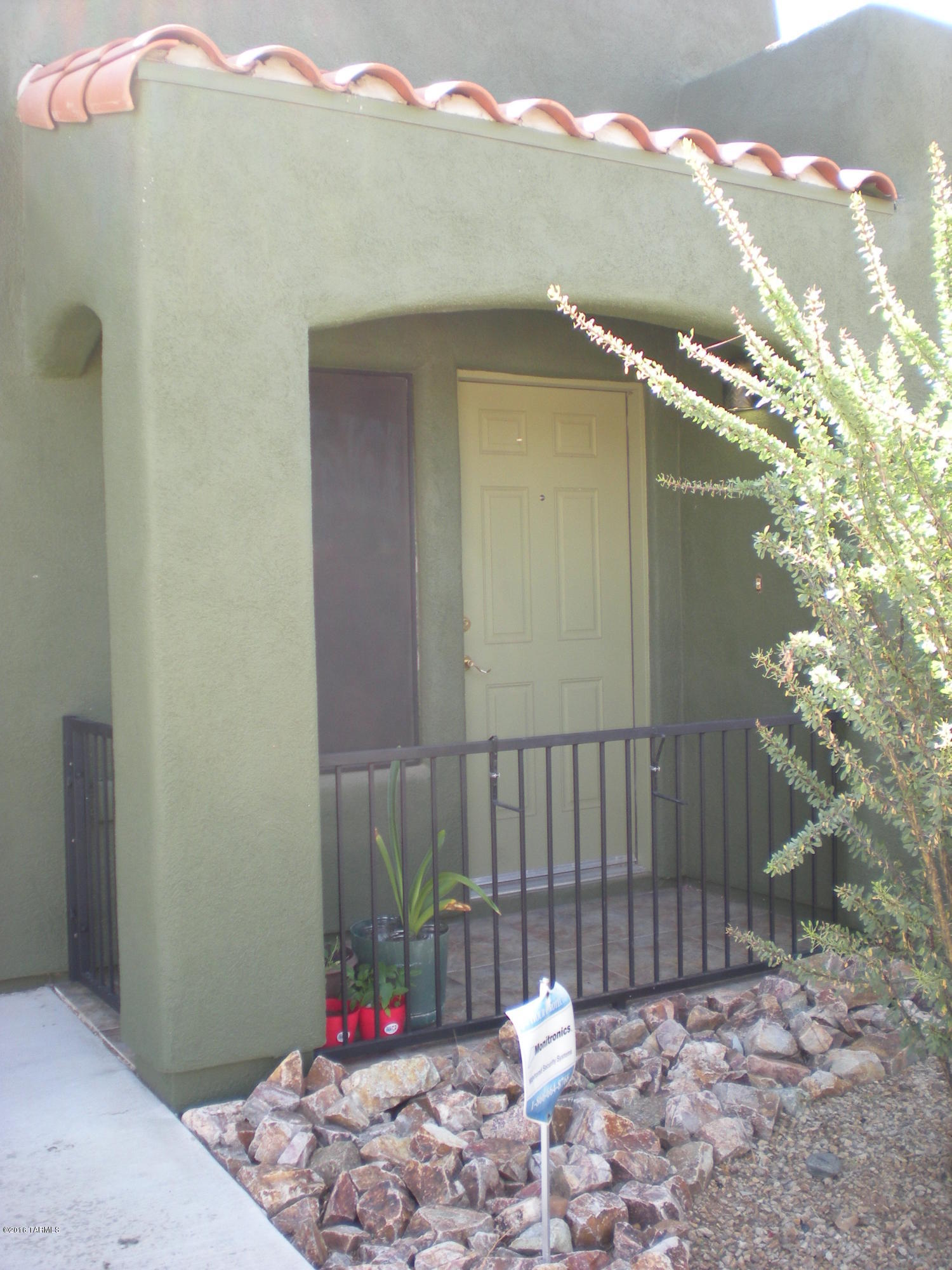 Adorable 3 bedroom/1 bath home on a corner lot with privacy on 3 sides! Charming gated front entry. Kitchen has lots of counter space, large breakfast bar area, window above kitchen sink which is on private side of home. Dining area off kitchen. All bedrooms have ample closet space. 2nd bedroom has sliding glass doors leading to covered back patio. Master bedroom has a french door leading to covered back patio. 3rd bedroom in front of home has 2 closets. Ceramic tile throughout.  Nice wooden blinds on most windows. Updated lighting fixtures. Plenty of room in private backyard. 1 car garage with washer and dryer that stays. Refrigerator also stays with home. Exterior was freshly painted in March 2016.